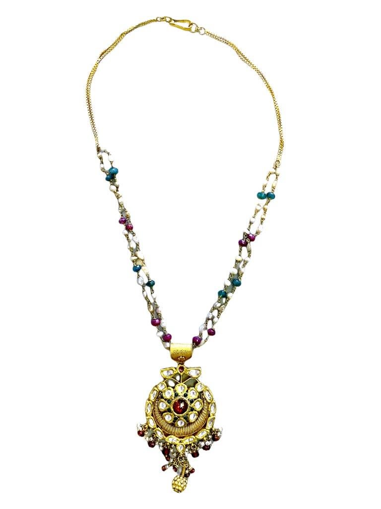 Indian-style pendants and chains are set with rubies, emeralds, diamonds, and pearls. A large style pendant bail features an elaborate chain with multi gemstones.  

The chain is 16 inches in length and is adorned with pearls, rubies, and emeralds