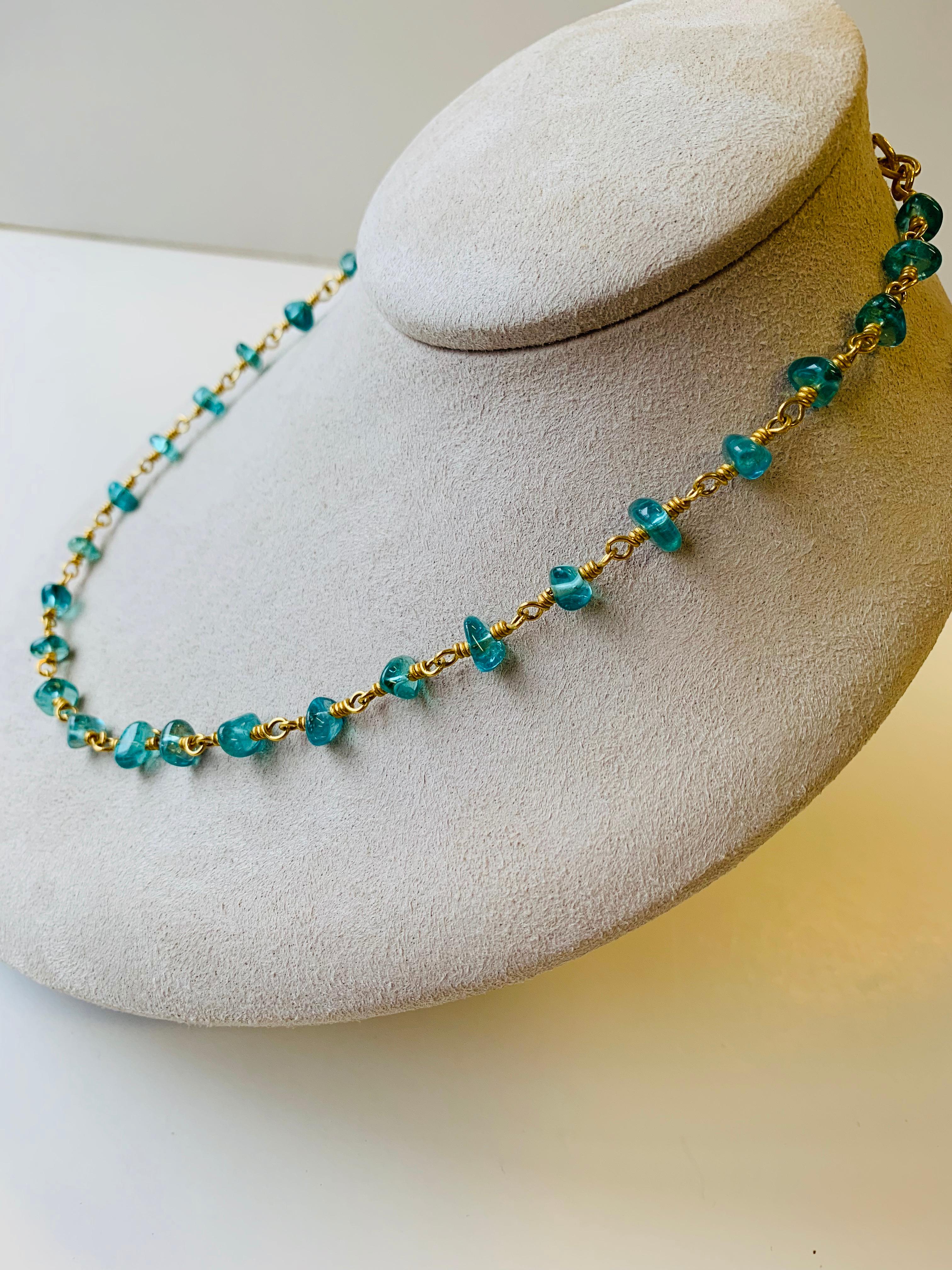 Necklace of luminous tumbled Apatite nuggets on 22 karat gold hand woven chain 18 inches long.
Hand made in NY