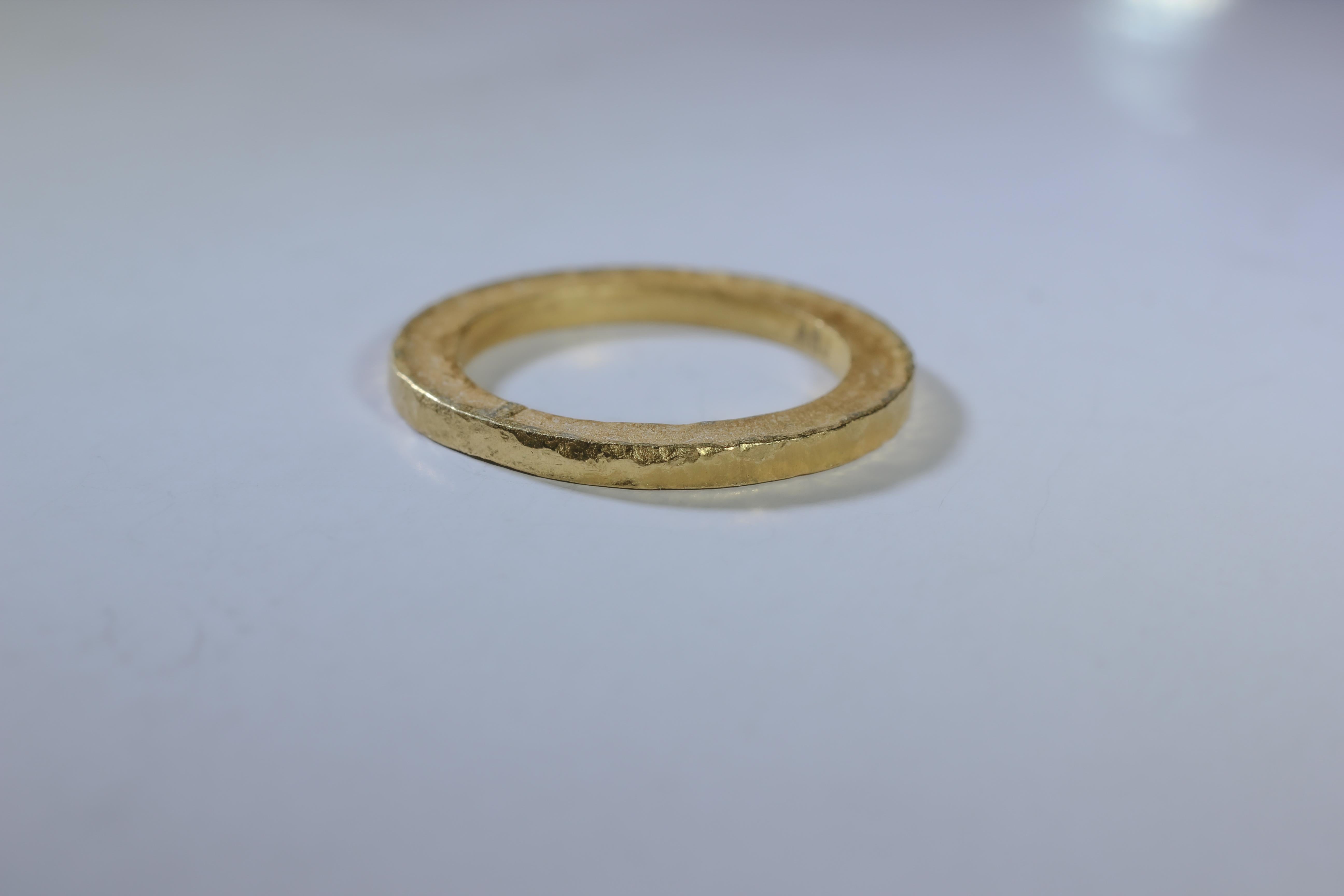 A bridal or wedding band ring in recycled 22K gold. The Simplicity Large Disk, a contemporary unisex wedding band ring is designed and handcrafted by AB Jewelry NYC. Ideal for a man or a woman. Wear it alone or as a fashionable stacking ring