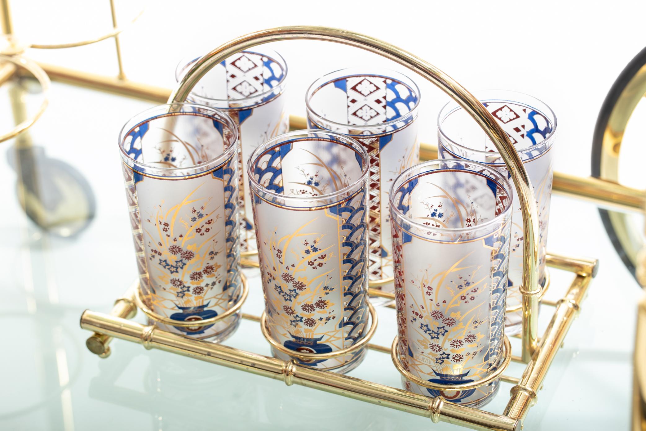 Vintage set of Chinoiserie pattern tumblers by Culver with 22-karat gold plating and matching brass bamboo caddy. Beautiful and unique addition for display on your bar cart or formal bar. Our shop carries additional pieces in this pattern so please