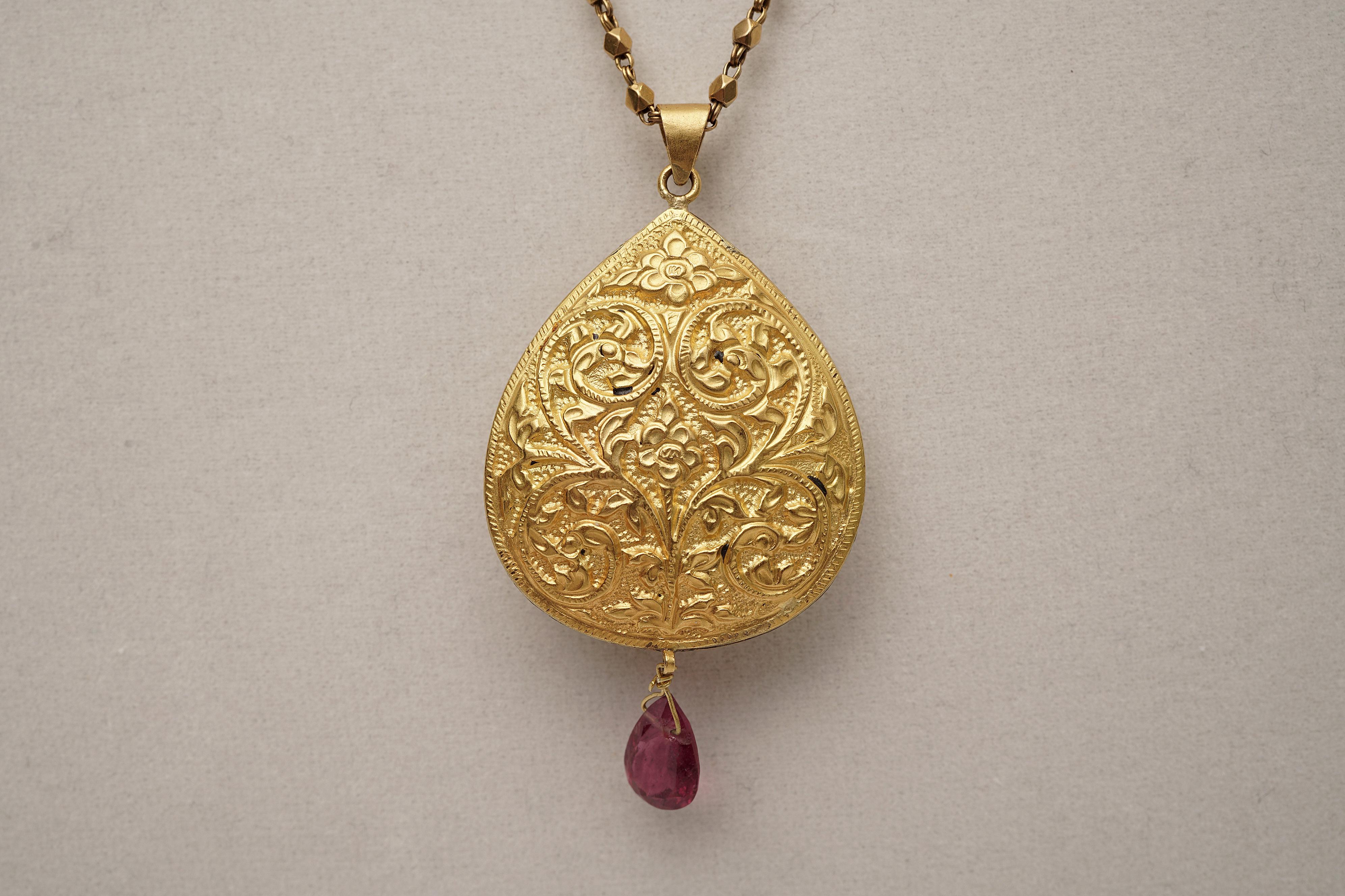 Lovely, dimensional 22K gold pendant with rose cut diamonds and pear-shaped, faceted pink tourmaline at center as well as the drop.  Fine hand-tooling work on both sides of the pendant, making it reversible.  Pendant suspends from a long beaded gold