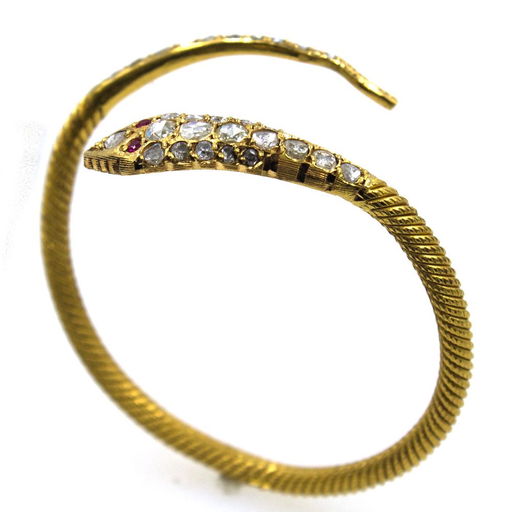 Fabulous vintage snake cuff crafted in 22 karat yellow gold. Beautifully crafted with 2.00 carat total weight of rose cut diamonds on the head and ruby eyes. The gold is textured to resemble snake skin and is slightly flexible. The bracelet measures