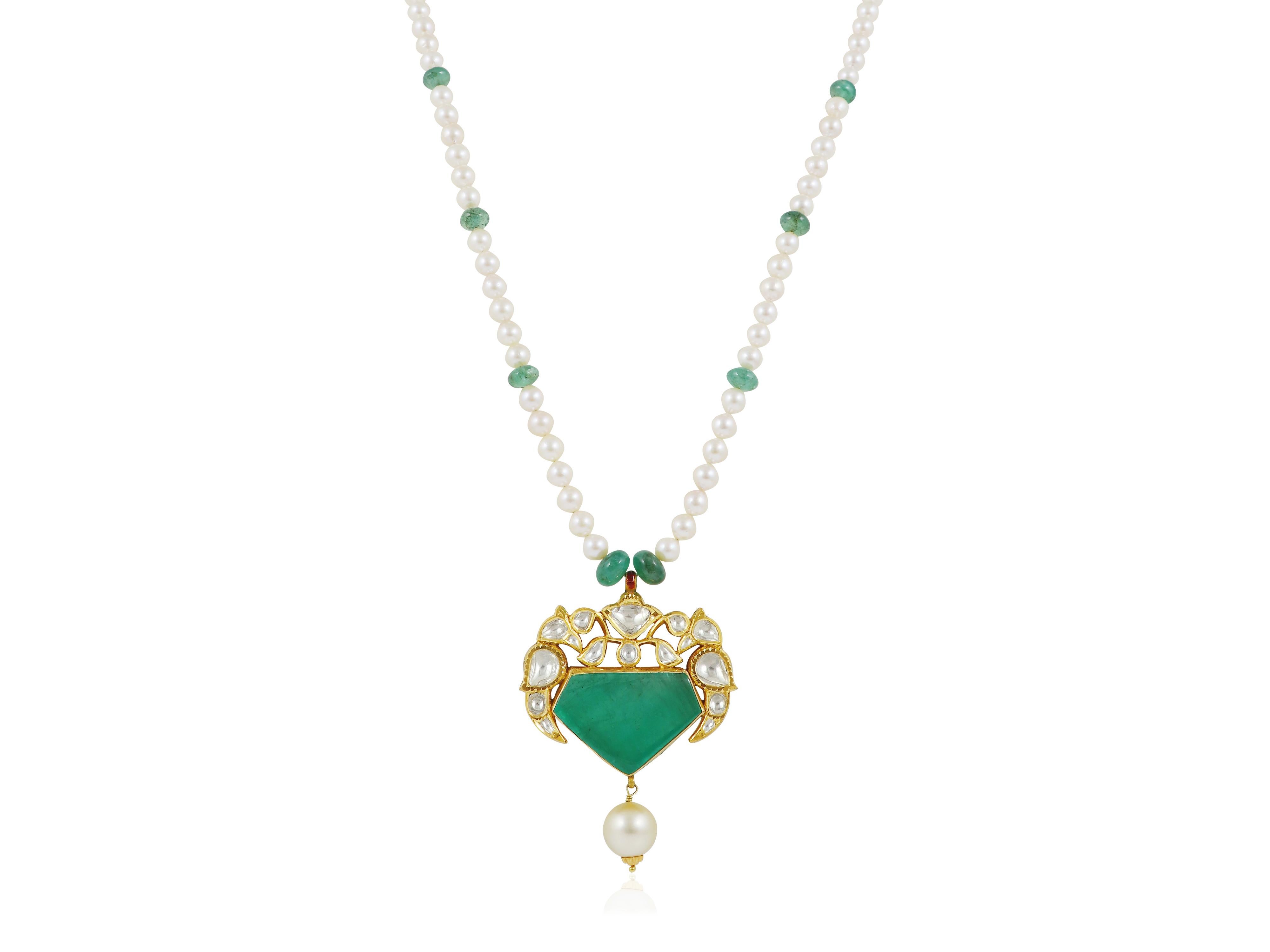 An elegant pendant in an open work design with a large 34.69ct emerald at centre, topped with two diamond set birds and flower. The reverse is polychrome enamelled.

The centre emerald is set in an open back setting to admire such clean piece of