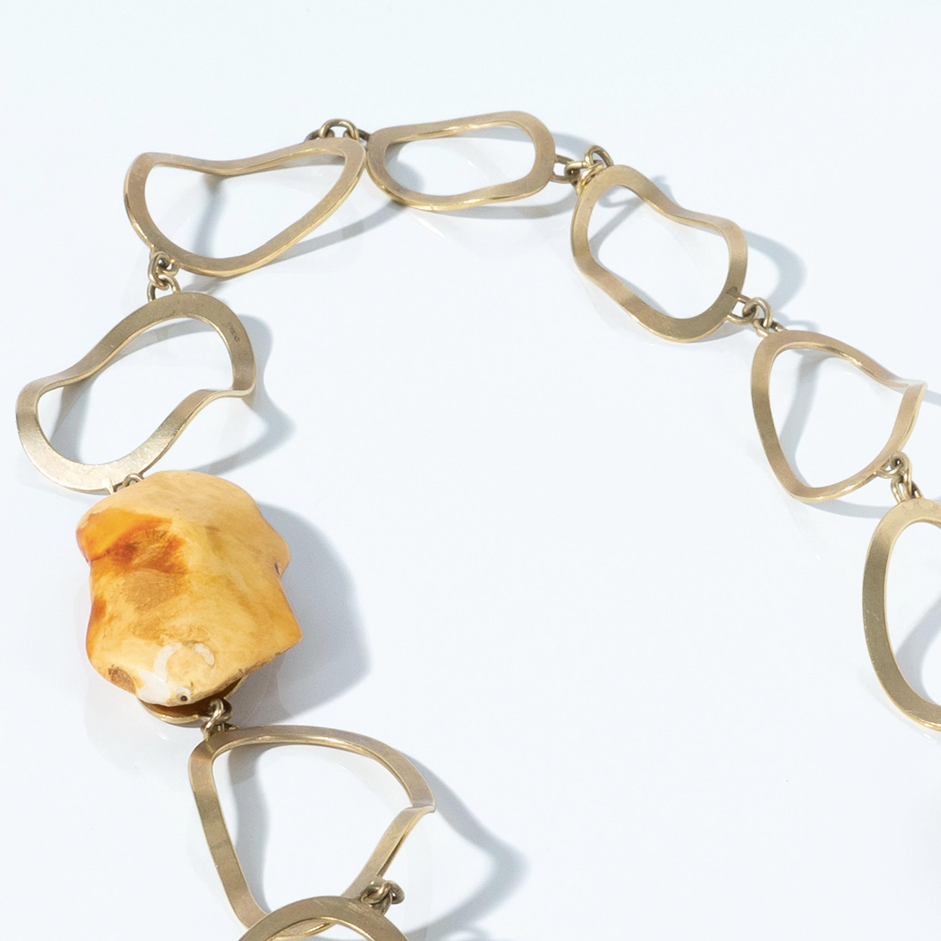 Artist Nan Nan Liu was asked by Mimi Lipton to create this one-of-a-kind piece of jewellery. Hand made links of 22 karat gold, reflect the cut of pieces of white amber from Estonia, in the Baltic region. Their rough form complimented by the
