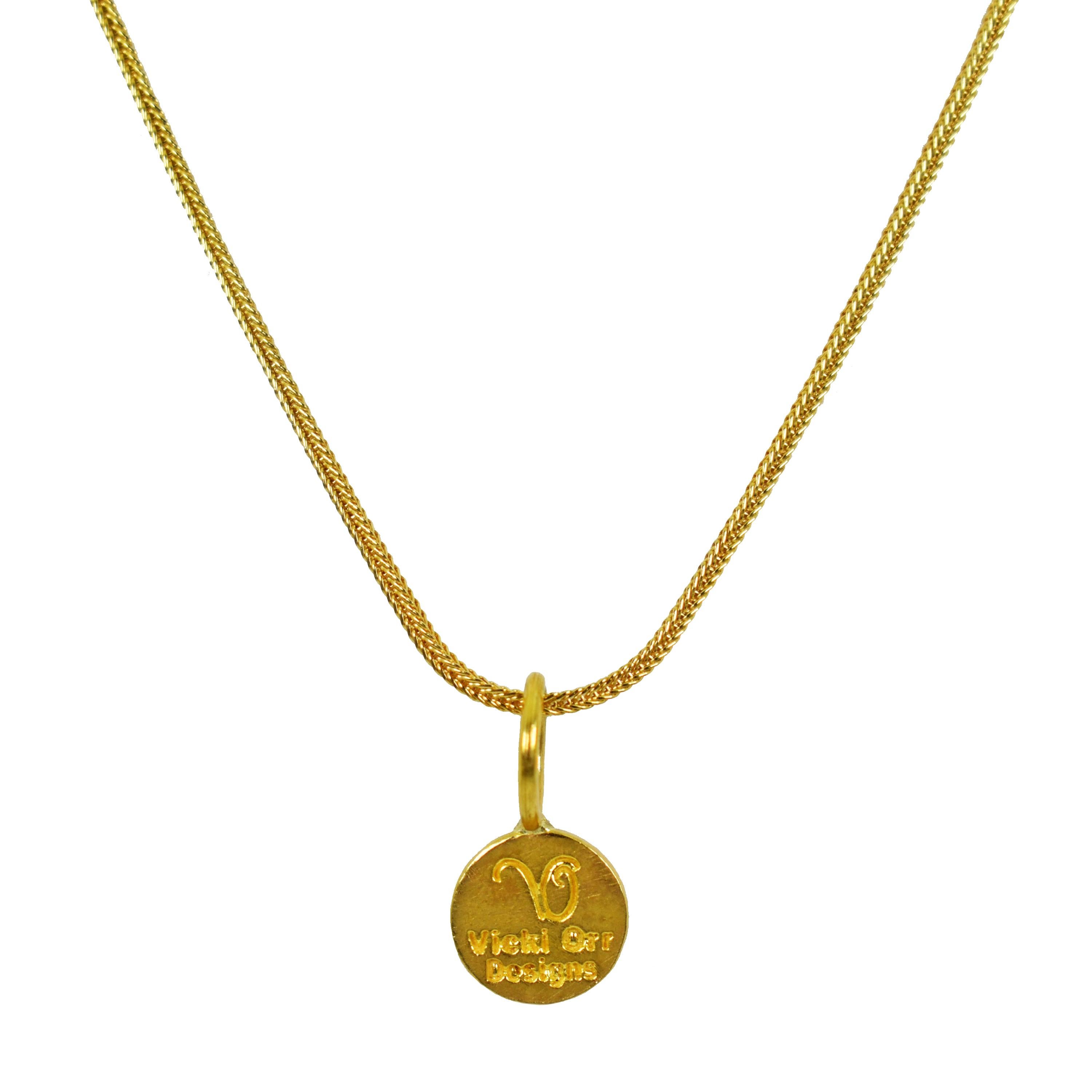 22k yellow gold ancient Greek Ixthus or Ichthus symbol charm pendant on an 18 inch 18k gold foxtail chain necklace. Charm pendant is 0.69 inch in length. 