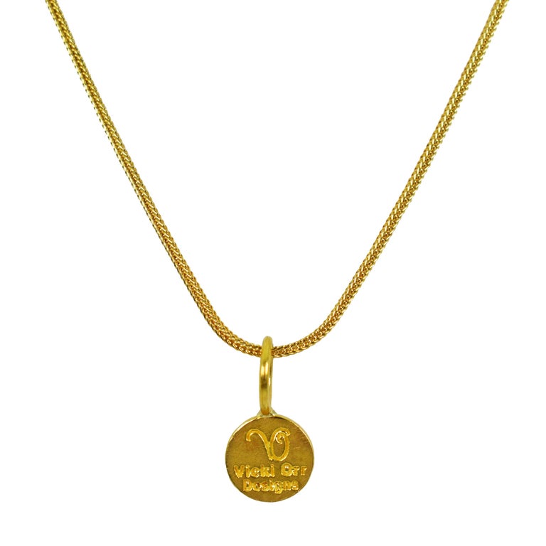 22k yellow gold ancient Greek Ixthus or Ichthus symbol charm pendant on an 18 inch 18k gold foxtail chain necklace. Charm pendant is 0.69 inch in length. 
