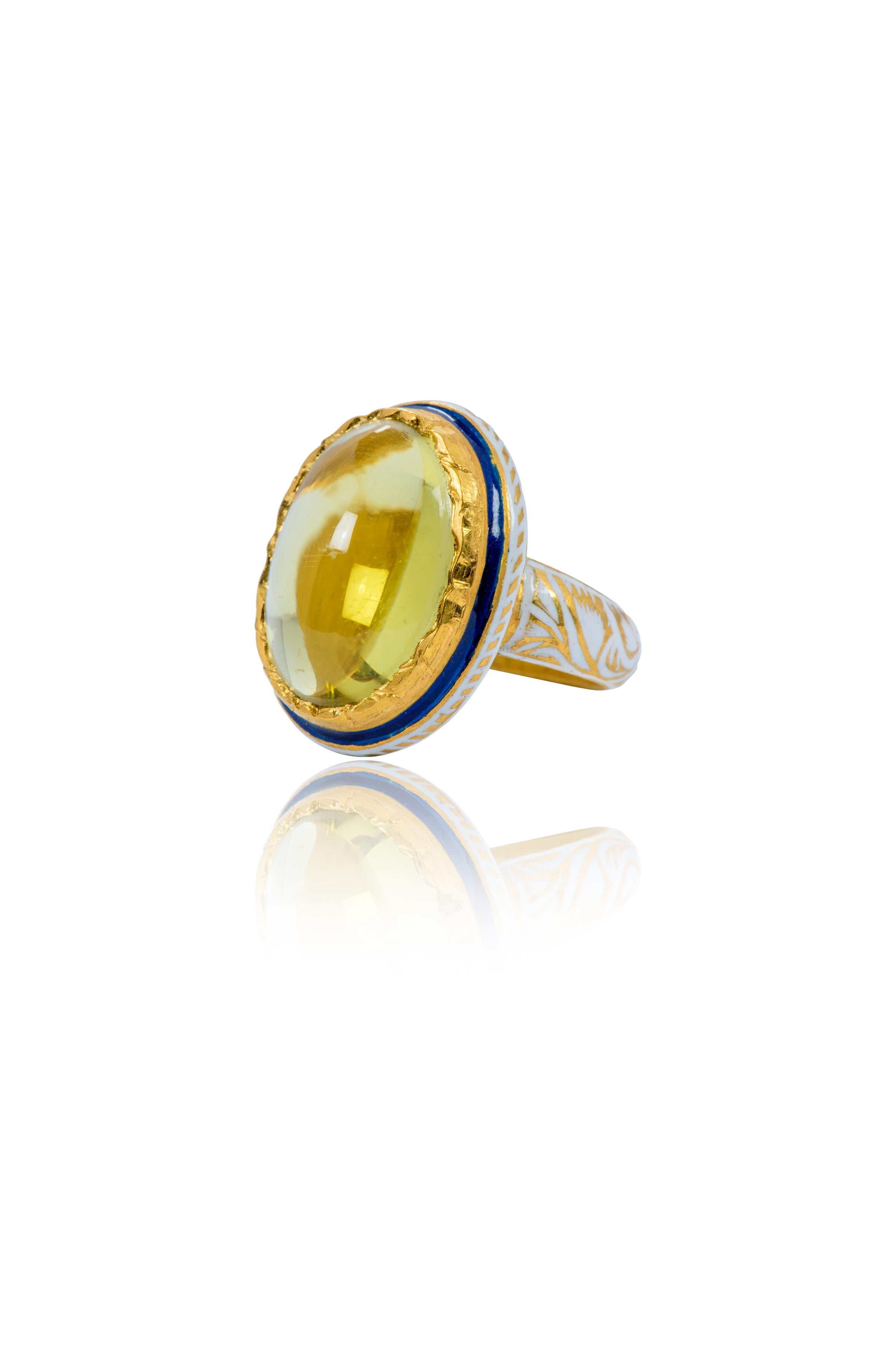 22 Karat Gold Lemon Topaz Cabochon Ring with White Enamel Work

This impressive Mughal era style hand-made tuscan sun lemon topaz ring with white enamel is majestic. The oval shaped solitaire lemon topaz cabochon is set in a hammered gold bezel