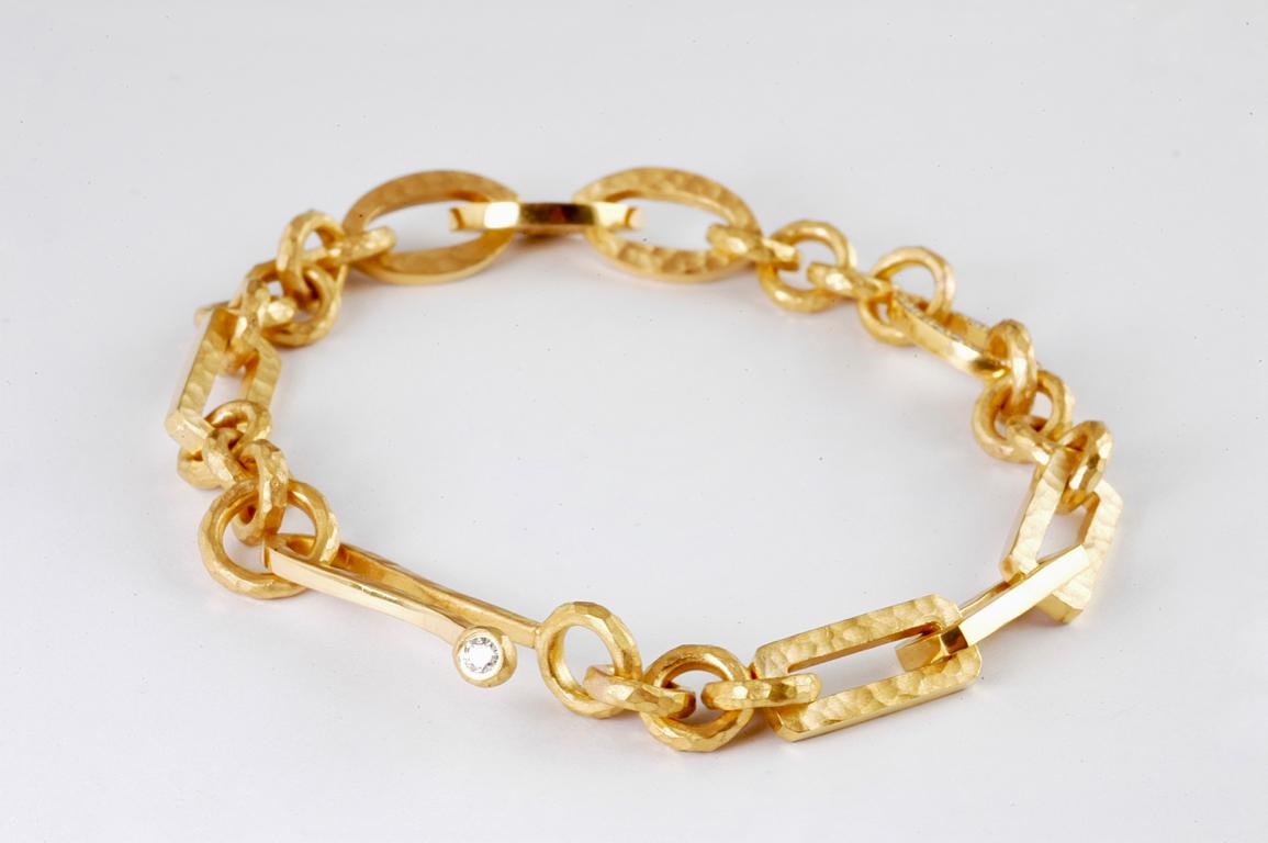 22ct gold mixed link bracelet with channel set diamond link approx 0.20cts total handmade link chain, handmade in London by renowned British jewellery designer Malcolm Betts.
With his own distinctive hand-beaten finish - Malcolm’s one of a kind