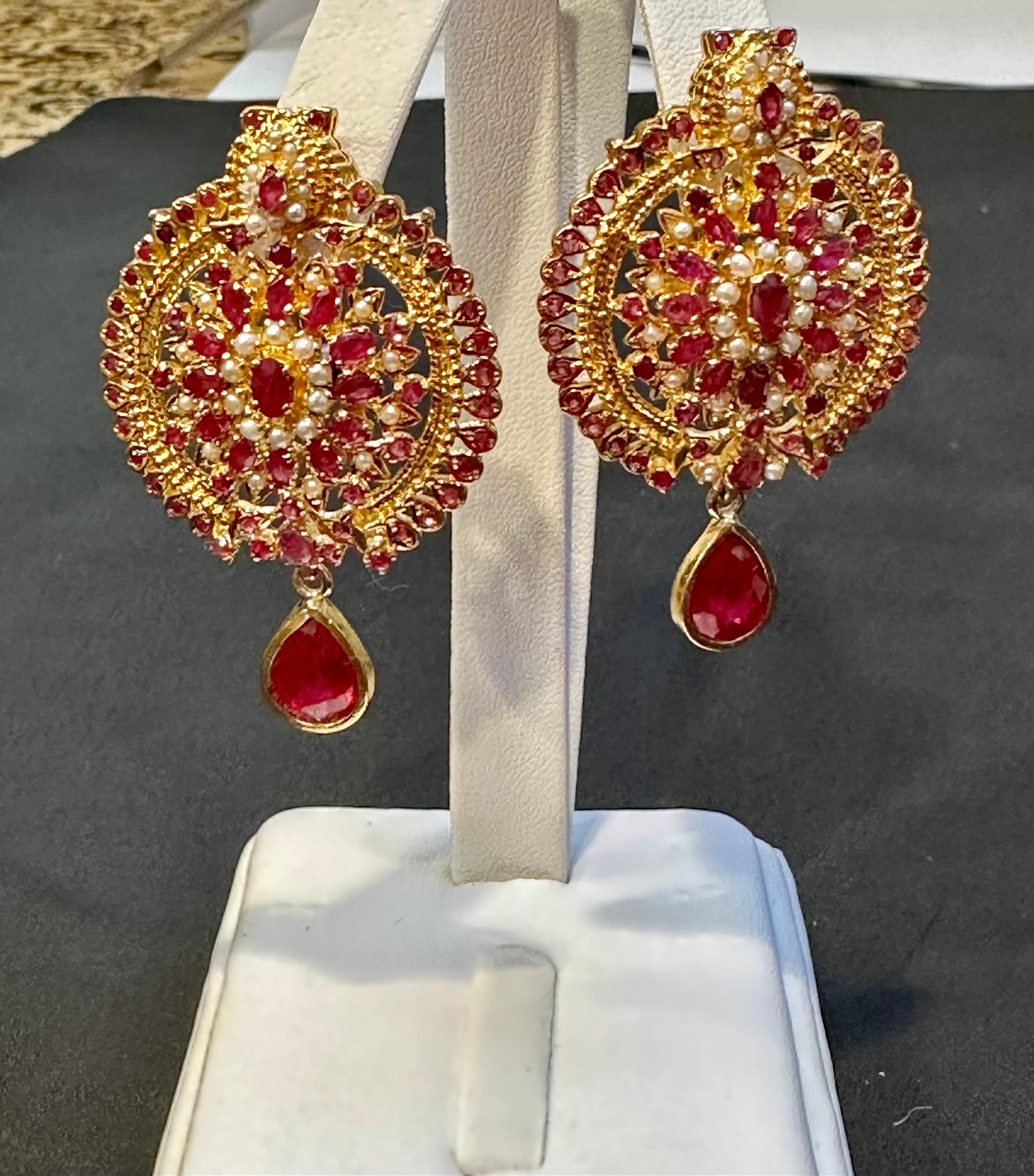 These exquisite stud earrings are a stunning example of fine jewelry craftsmanship. They are beautifully crafted with 22 karat yellow gold, making them a valuable addition to any collection. The earrings are post style with omega backs, ensuring