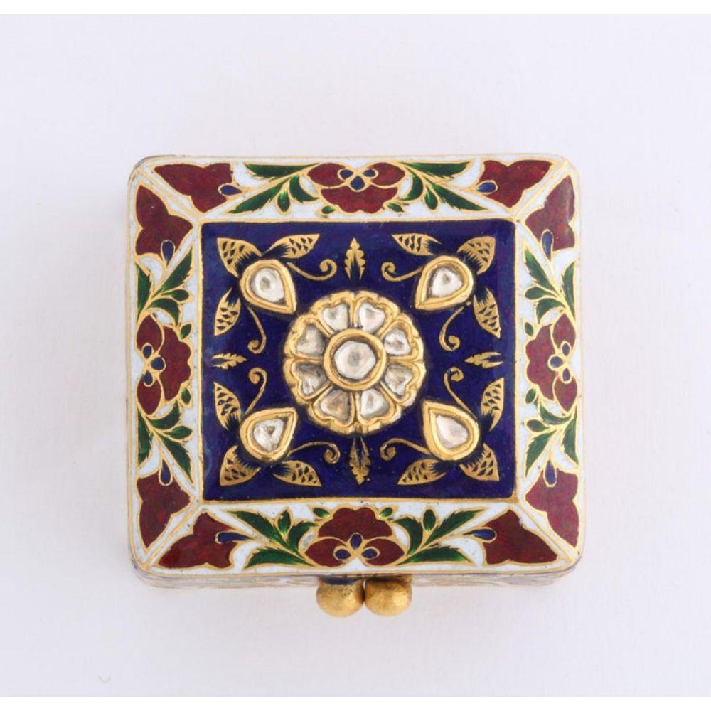 22-karat Indian gold enamel and diamonds pill snuff box, Mughal style, Jaipur.  

Finely painted with flowers, set with rose-cut diamonds, the lid opens to hand painted enameled peacock.  

Very high quality object.   

Weighs 42 grams.  