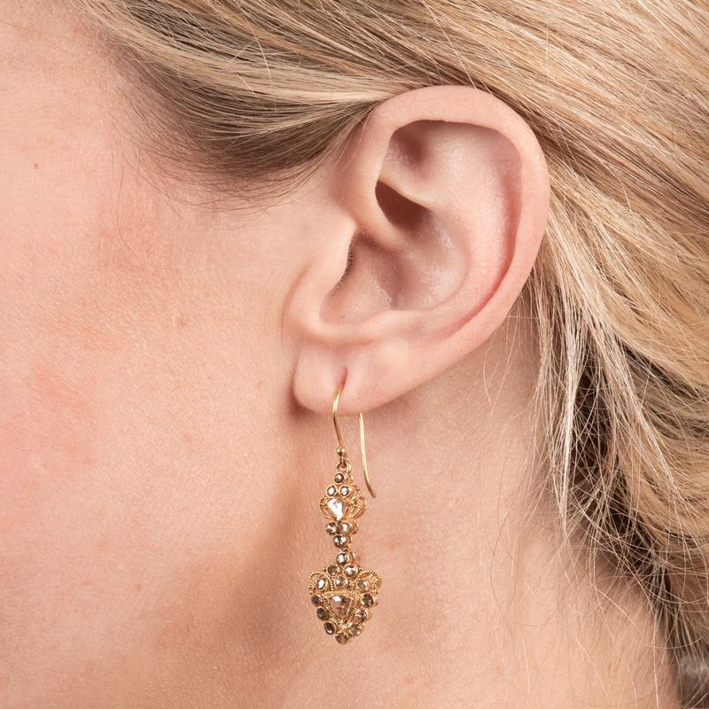 These vintage earrings feature 1.75 carat total weight in rose cut diamonds with filigree detailing. They are set in 22 karat yellow gold. 
Measurements: Length approximately 1.75