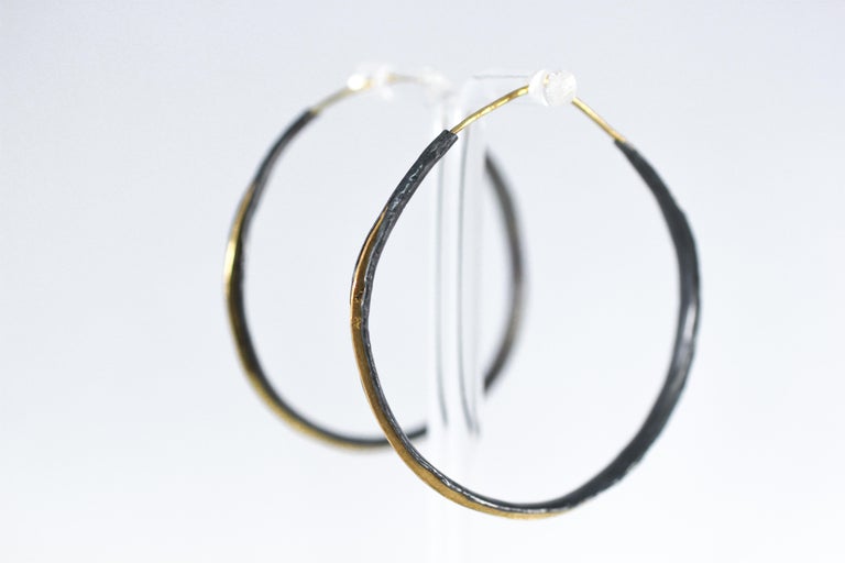 Graduation Hoops dangle earrings. Striking black oxidized silver handmade organic hand shaped hoops with a contrasting 21k gold hoop detail. These striking modern hoops are perfect for any occasion. They are light and make a dramatic