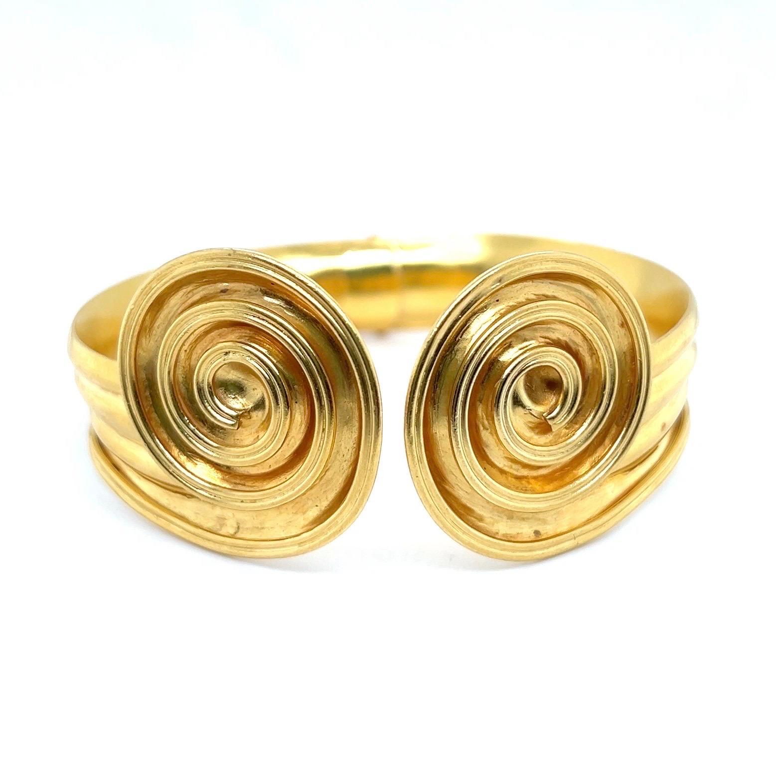 Goddesslike 22 karat yellow gold bangle bracelet by Lalaounis, 1970s.

Crafted in yellow gold, this wonderful hinged bangle features a fluted surface and two spiral motifs as endings.

Greek master Ilias Lalaounis founded his iconic jewelry brand in