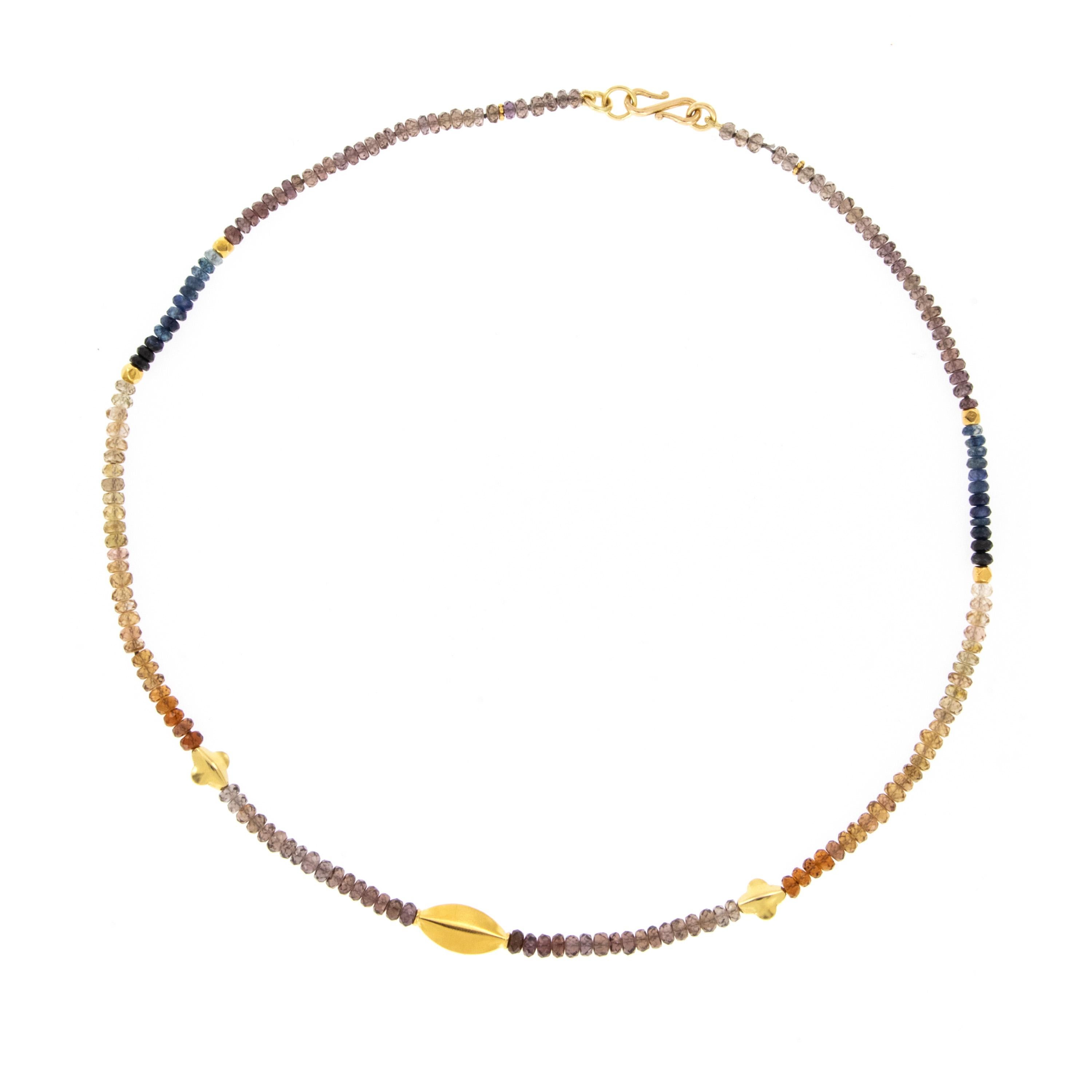 Beautiful and softly hued faceted sapphire beads are hand strung in ombre' fashion accented with satin finished 22 karat yellow gold station beads and is 16
