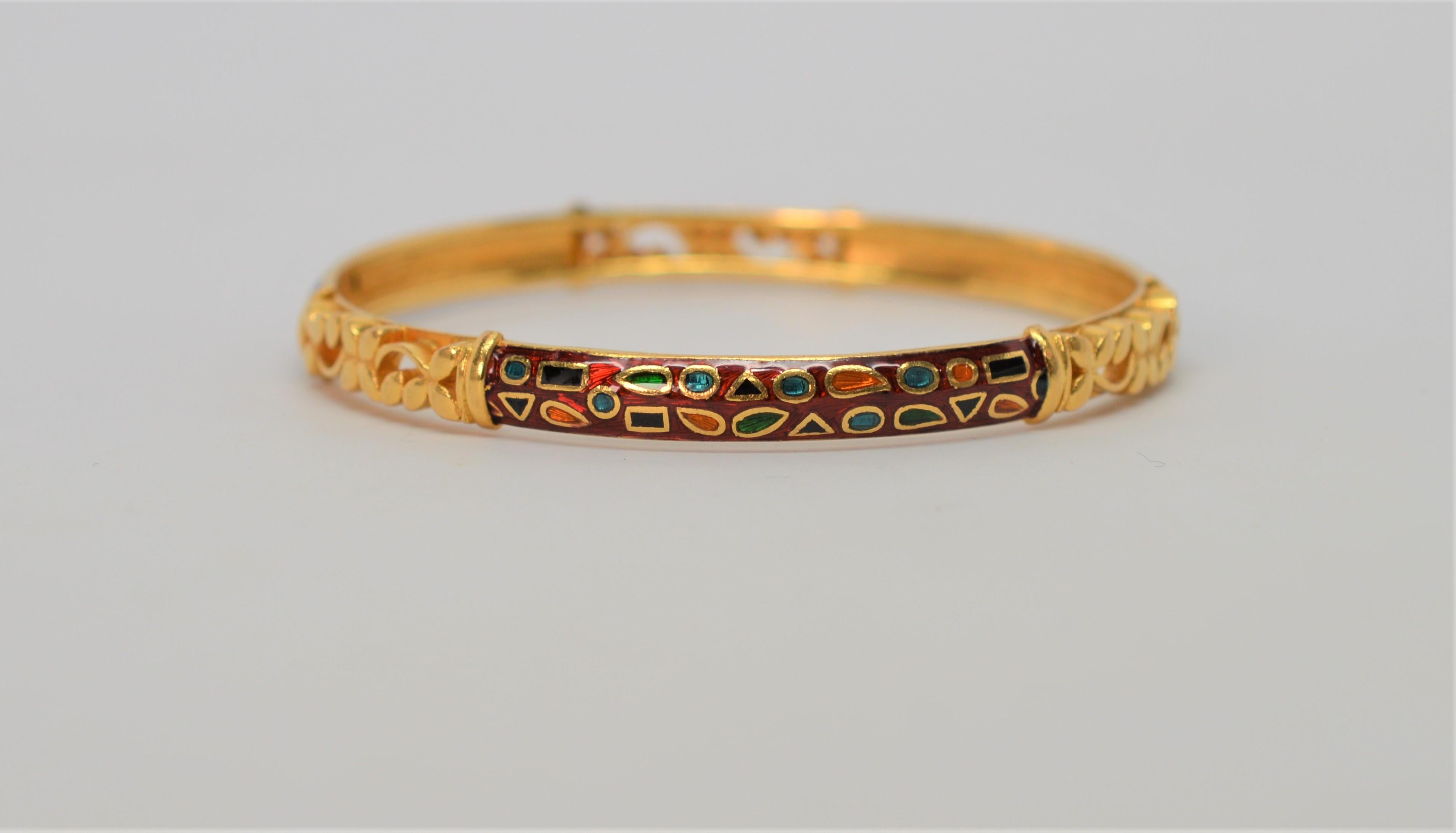 A kaleidoscope of colors decorate this 22 Karat Yellow Gold Bracelet with its expertly hand-applied enamel design. Measuring 2-1/4 inches in diameter and with a 7 inches circumference, the design is complimented with gold filigree plackets. In gift