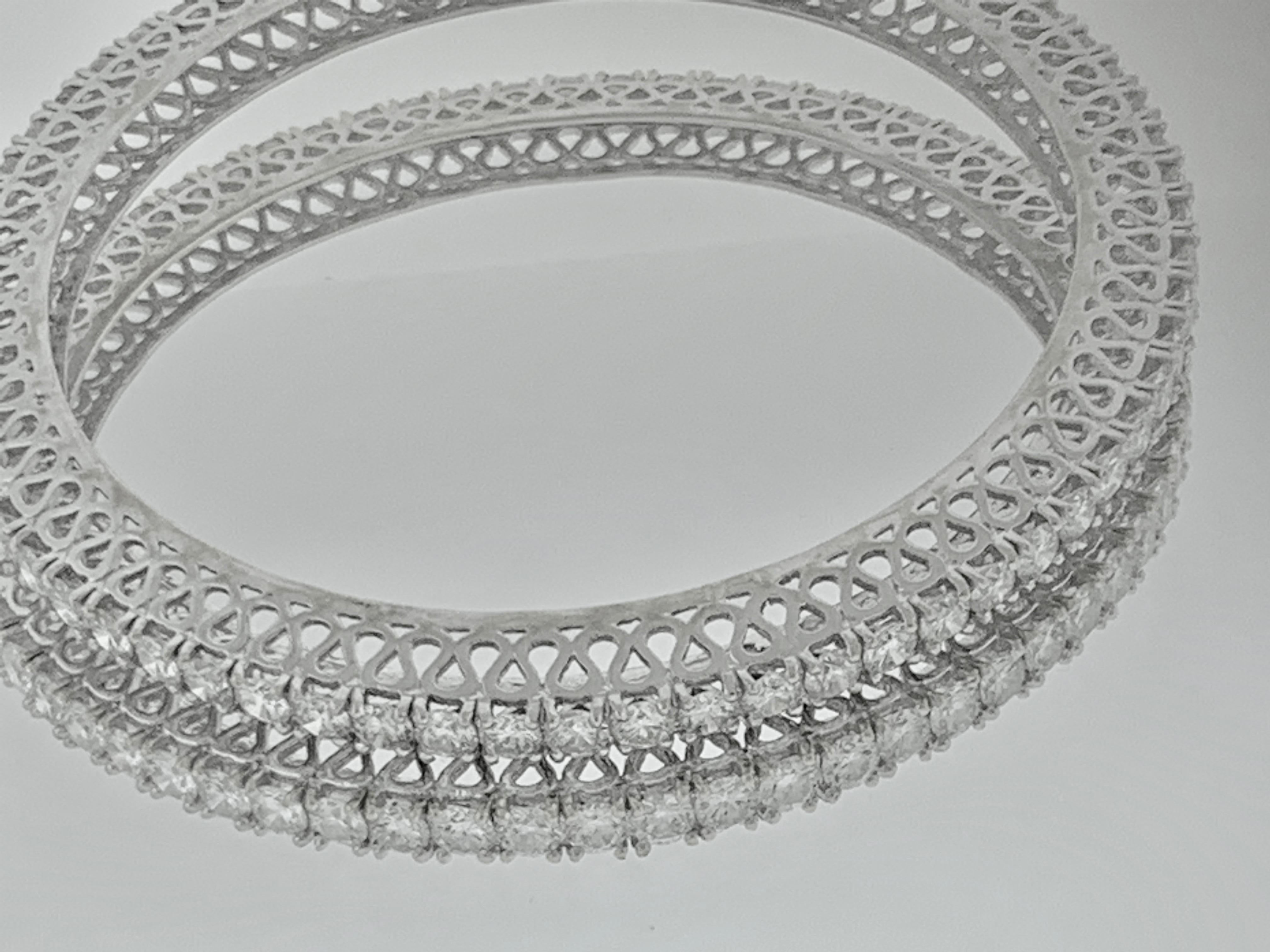 Single line 22 pointer  each , 29 Ct Contemporary  18 Karat  White  Gold & Diamond  Eternity Bangle Bracelet 
It features Two  bangles  crafted from  14k White gold   embedded with  29 Carats of  Round brilliant diamonds in two bangles 
The  pattern