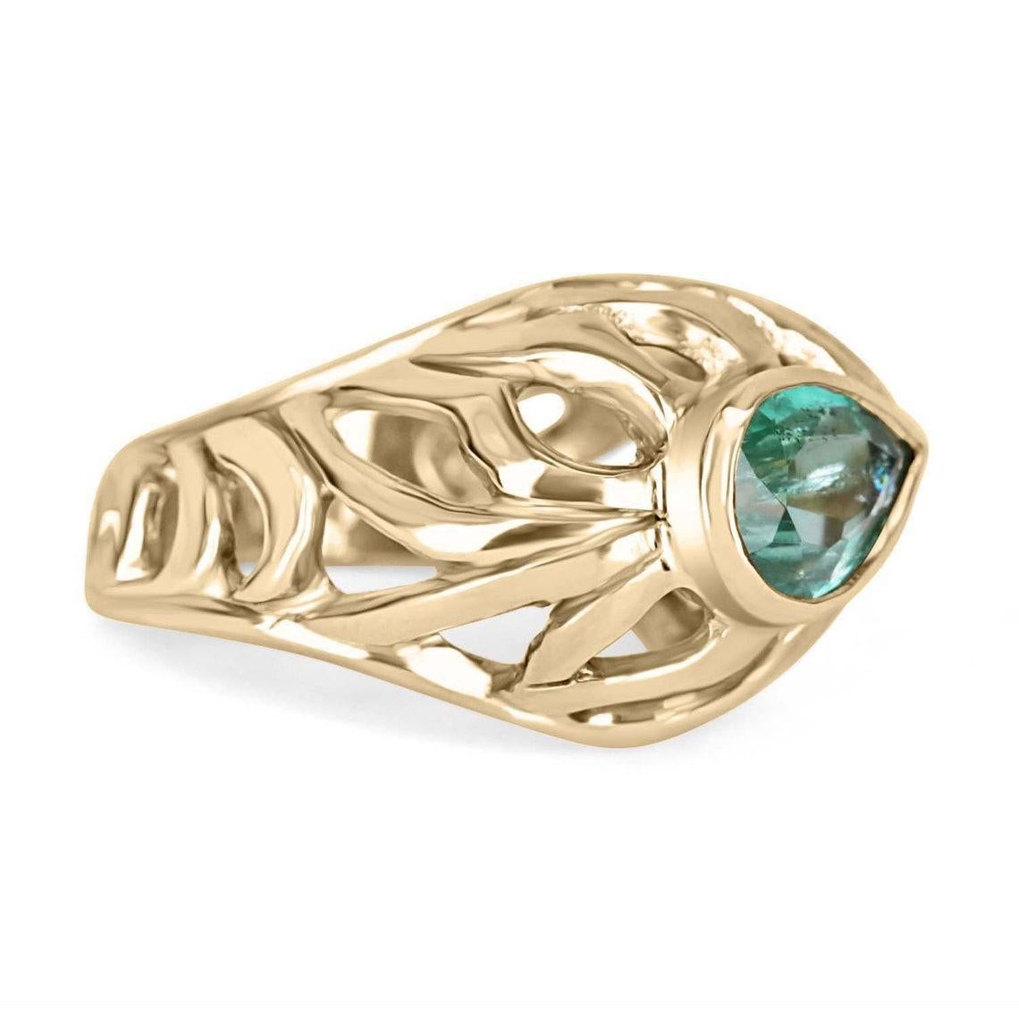 Featured is a 2.20-carat solid gold pear cut emerald, handmade solitaire ring. The smoothly carved cutouts outline the shape of tiger stripes and create an intricate design. In the center, a gorgeous 2.20ct natural emerald sits in a golden bezel.