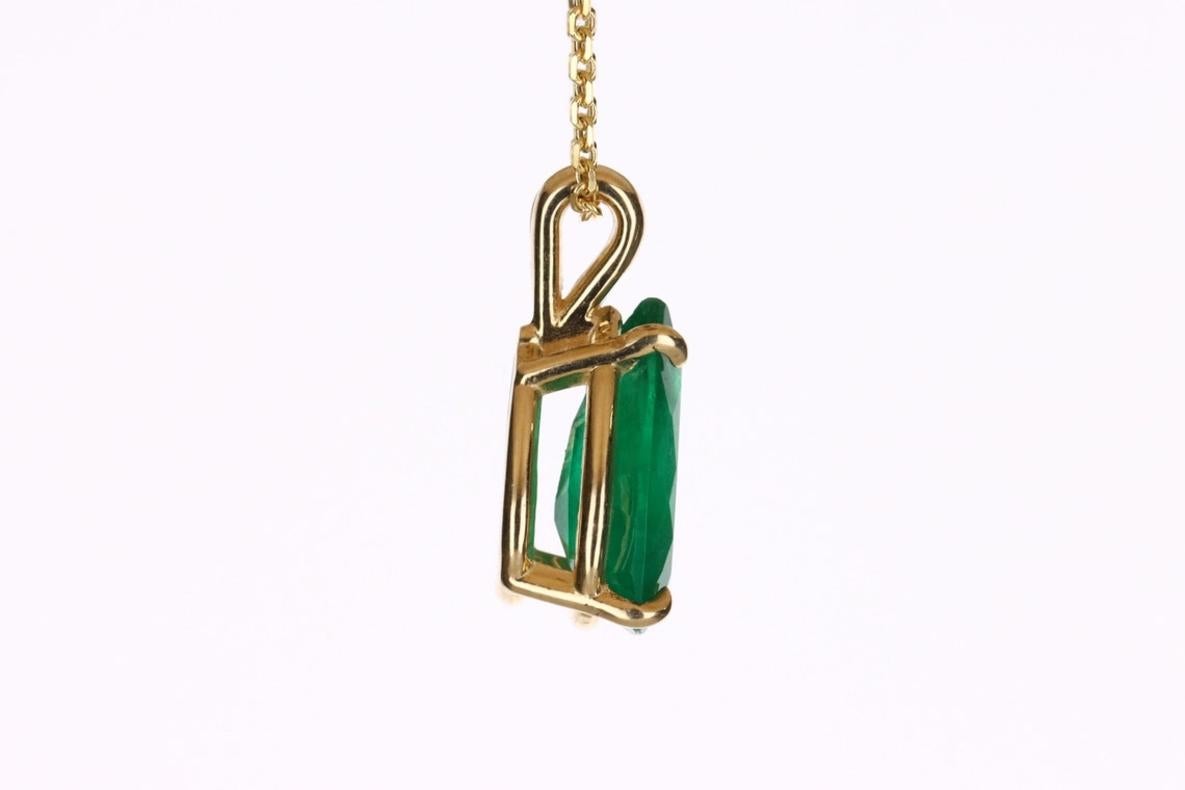 Featured here is a stunning, pear emerald pendant in fine 14k yellow gold. Displayed in the center is a medium-rich green emerald set in a gold four-prong classic mount. The earth mined, green emerald has a desirable lush green color. This emerald