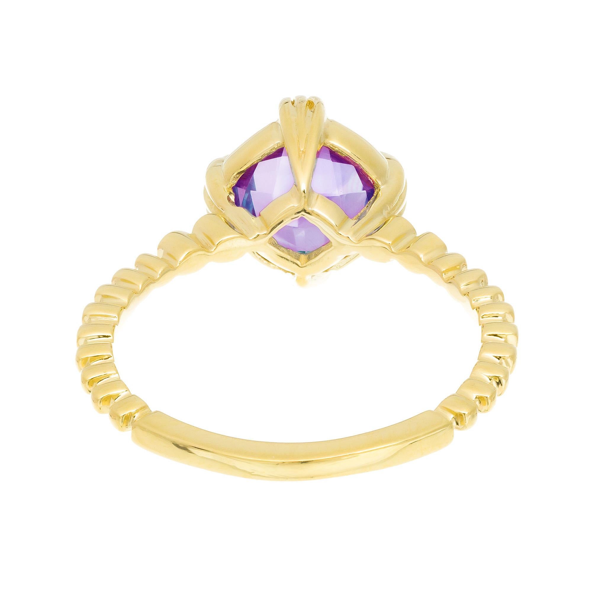 Topaz, amethyst and diamond ring. Center faceted blue topaz with a faceted amethyst on the other side of the topaz ( back) only scene form the inside. 18k yellow gold setting with 4 accent diamonds. 

1 round faceted dome blue topaz, approx.