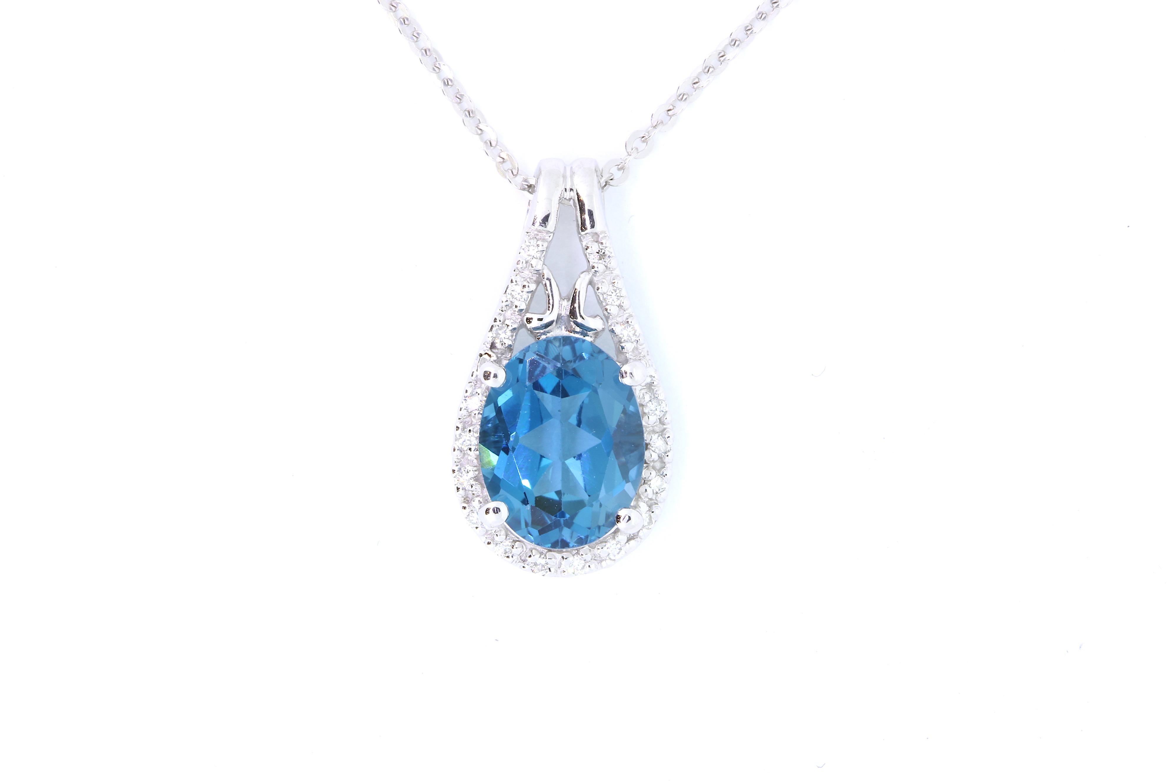 Material: 14k White Gold 
Center Stone Details: 2.20 Carat Blue Topaz
Diamond Details: 18 White Diamonds at Approximately 0.07 Carats - Clarity: SI / Color: H-I
Chain: 18 inch

Fine one-of-a-kind craftsmanship meets incredible quality in this