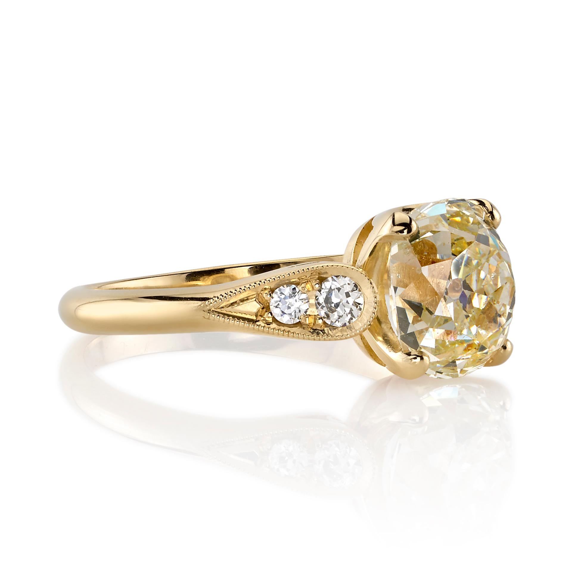 2.20ctw O-P/SI2 GIA certified vintage Cushion cut diamond with 0.14ctw old European cut accent diamonds set in a handcrafted 18K yellow gold mounting.

Ring is a size 6 and can be sized to fit.