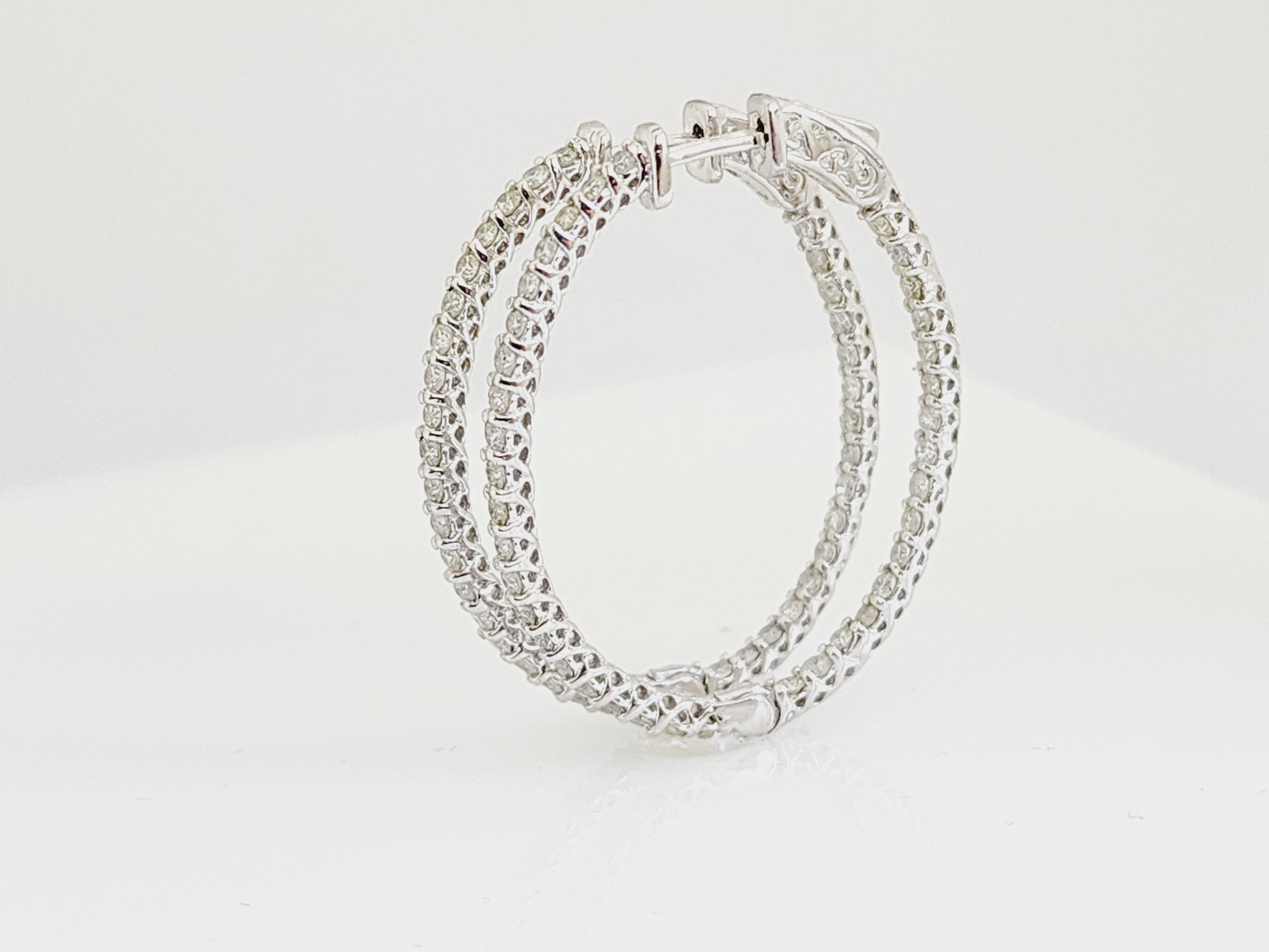 Beautiful pair of natural diamond inside out oval hoop earrings in 14K white gold. 
Secures with push down insert closure for easy wear. 
Average Color I-J, Clarity SI, 
Measures 1.25 inch x 1 inch. 