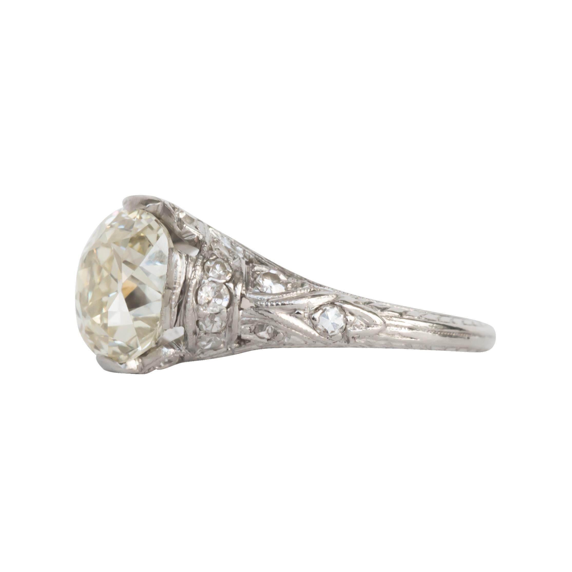 Item Details: 
Ring Size: 5
Metal Type: Platinum [Hallmarked, and Tested]
Weight: 4.2 grams

Center Diamond Details:
Weight: 2.20 carat
Cut: Antique Cushion
Color: N
Clarity: VS2

Side Diamond Details:
Weight: .20 carat total weight
Cut: Antique