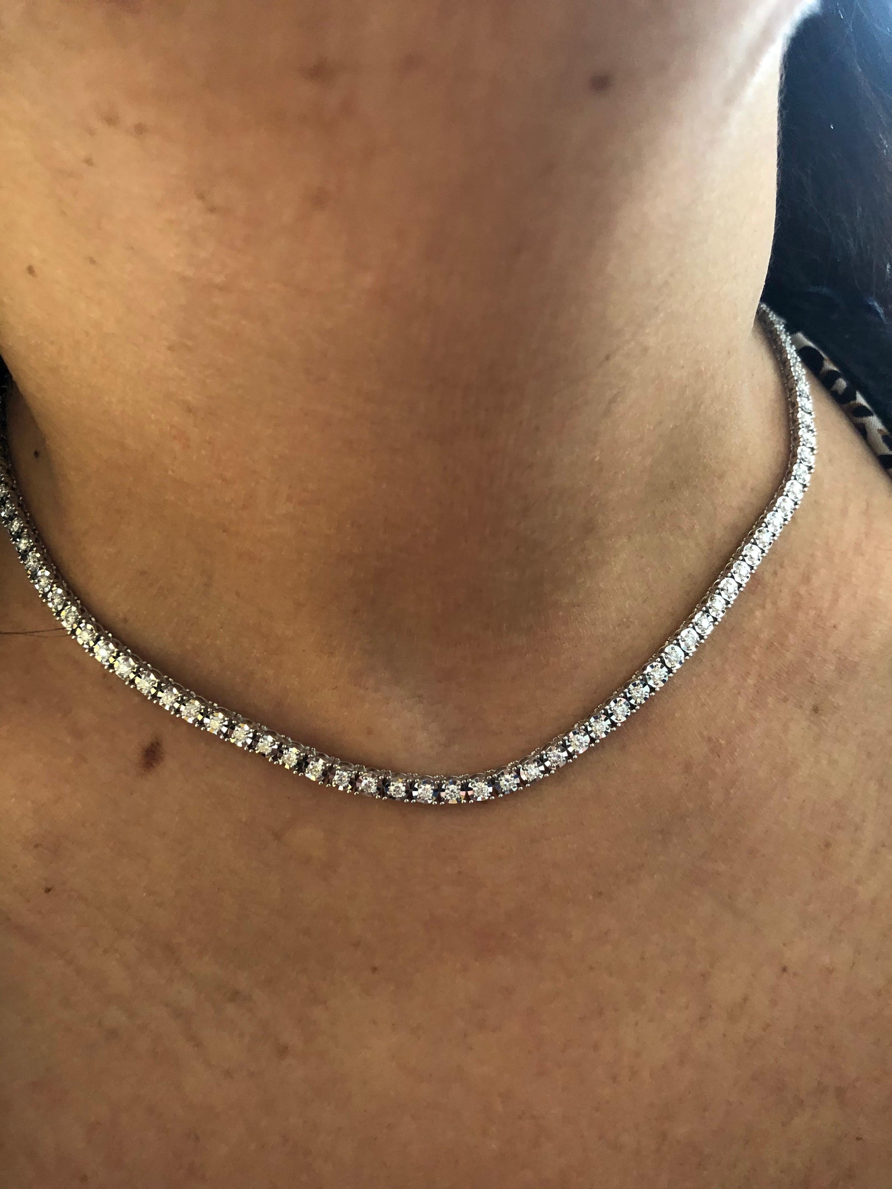 Tennis necklace set 3/4 of the way around in 14K white gold. The necklace is set in a mirror illusion setting. The necklace is 16 inch and is manufactured in Italy. The diamond weight is 2.20 carats. The color of the stones are G, the clarity is