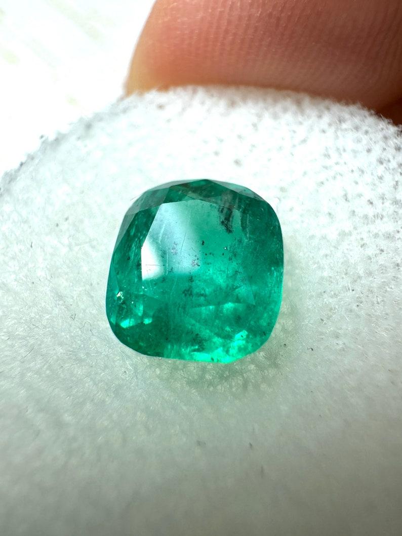 Stone: Emerald
Weight: 2.20-carats
Shape: Cushion Cut
Clarity: Transparent, Visibly included
Luster: Very Good
Color: Medium Dark Green
Measurements: 8.38mm x 7.44mm x 5.47mm
Geographic Origin: Colombia
Treatment: Natural, Oiling

Comments: Due to