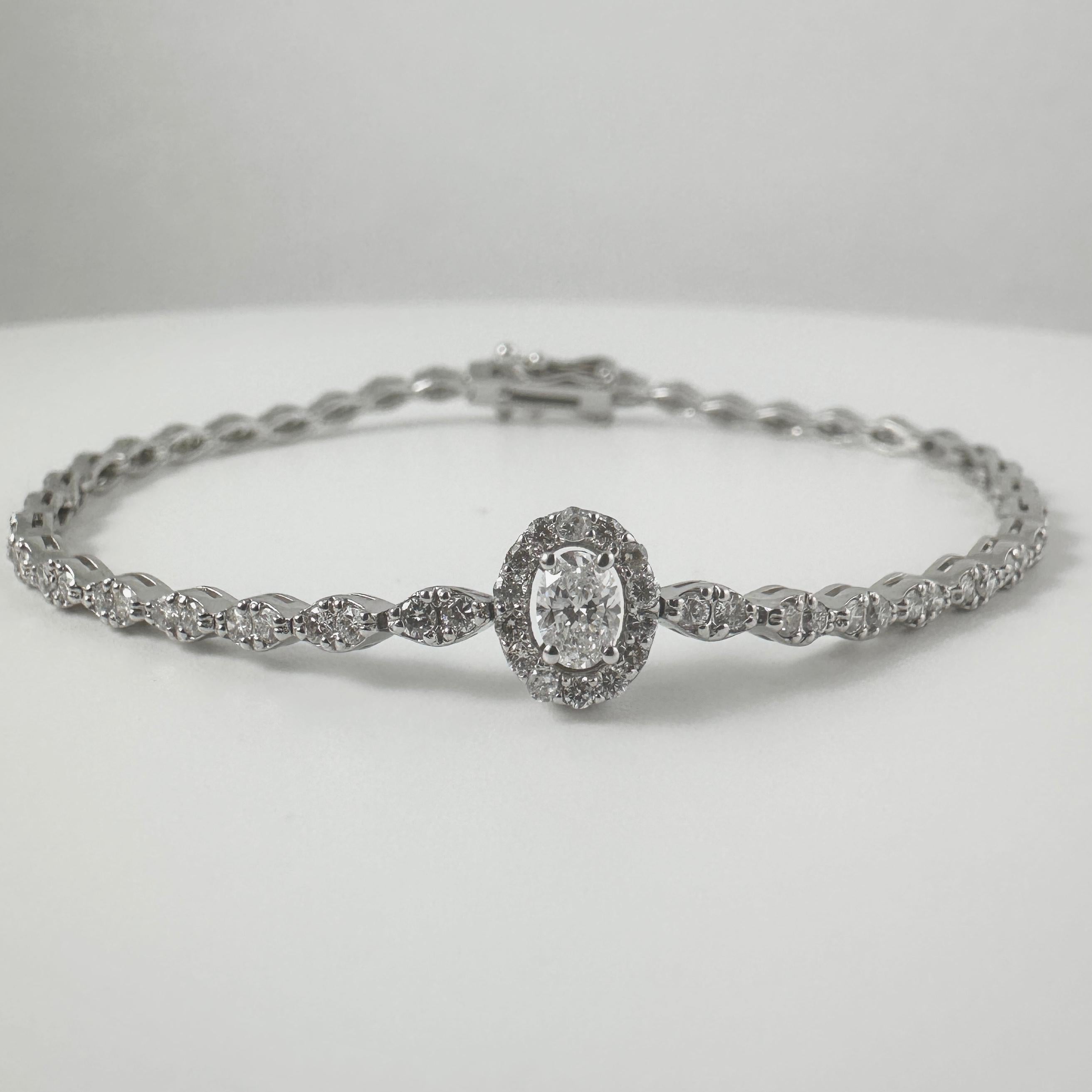 This elegant bracelet features a 0.25 carat oval-cut diamond center, encircled by a halo of sparkling round diamonds in G-H color and SI clarity, enhancing the brilliance of the centerpiece.

The bracelet design continues with all round diamond
