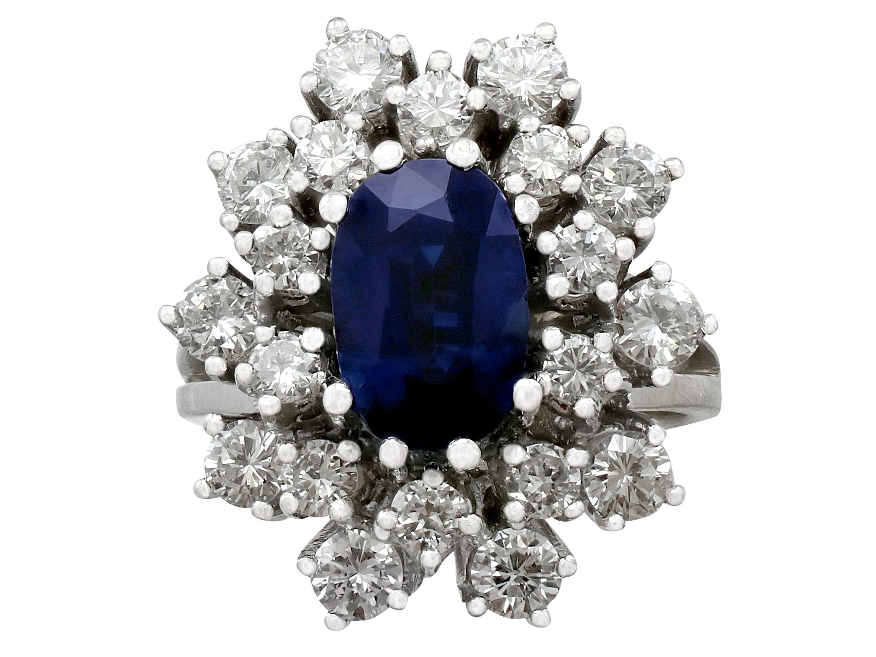 A stunning vintage 2.20 carat sapphire and 2.54 carat diamond, 14 karat white gold dress ring; part of our diverse vintage estate jewelry collections.

This stunning, fine and impressive vintage sapphire and diamond cluster ring has been crafted in