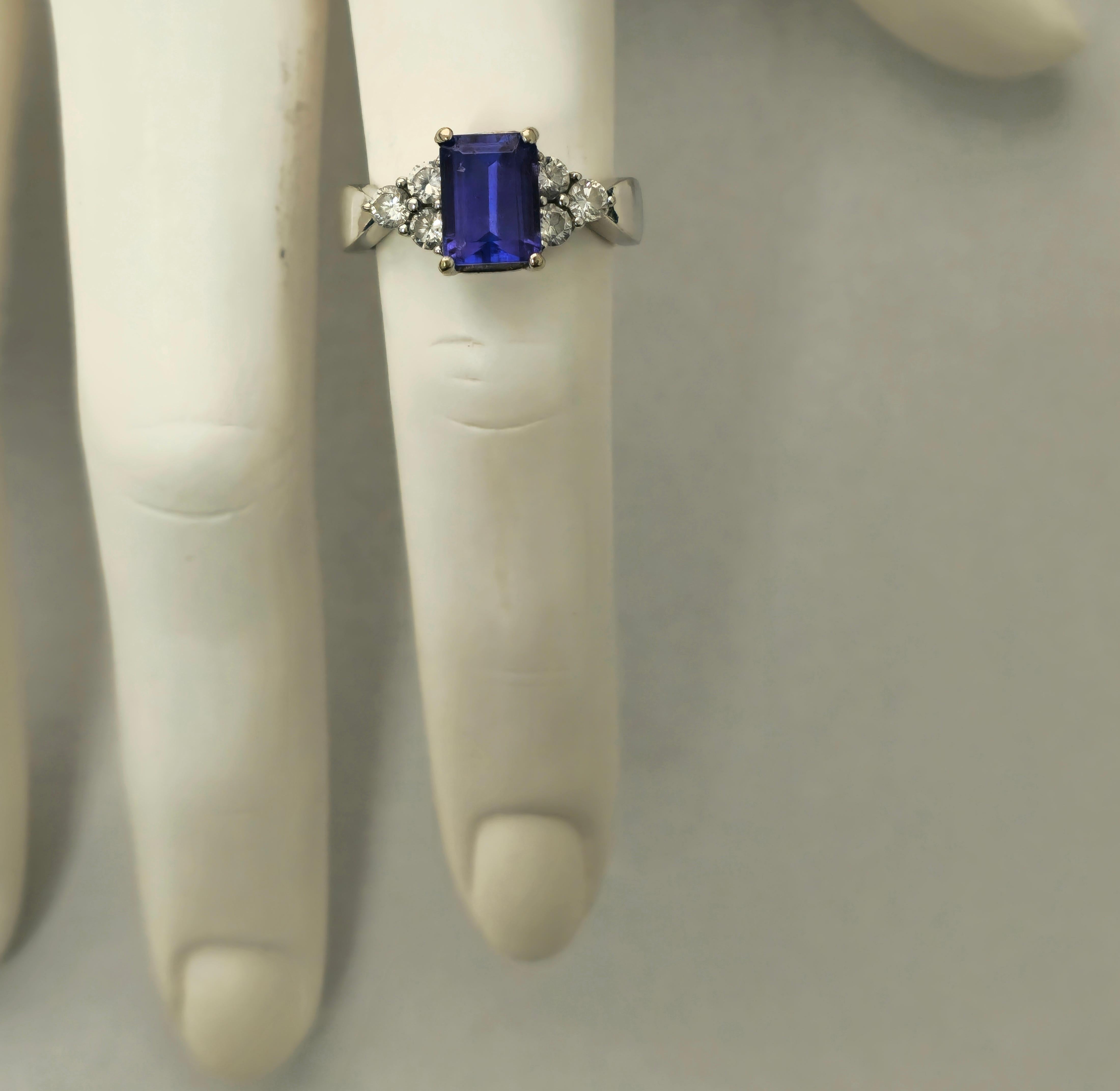 Fashioned from luxurious 14k white gold, this exquisite cocktail ring features a mesmerizing 2.20 carat tanzanite, cut in an elegant emerald shape, sourced directly from the earth's treasures. Accentuating its allure are brilliant diamonds totaling
