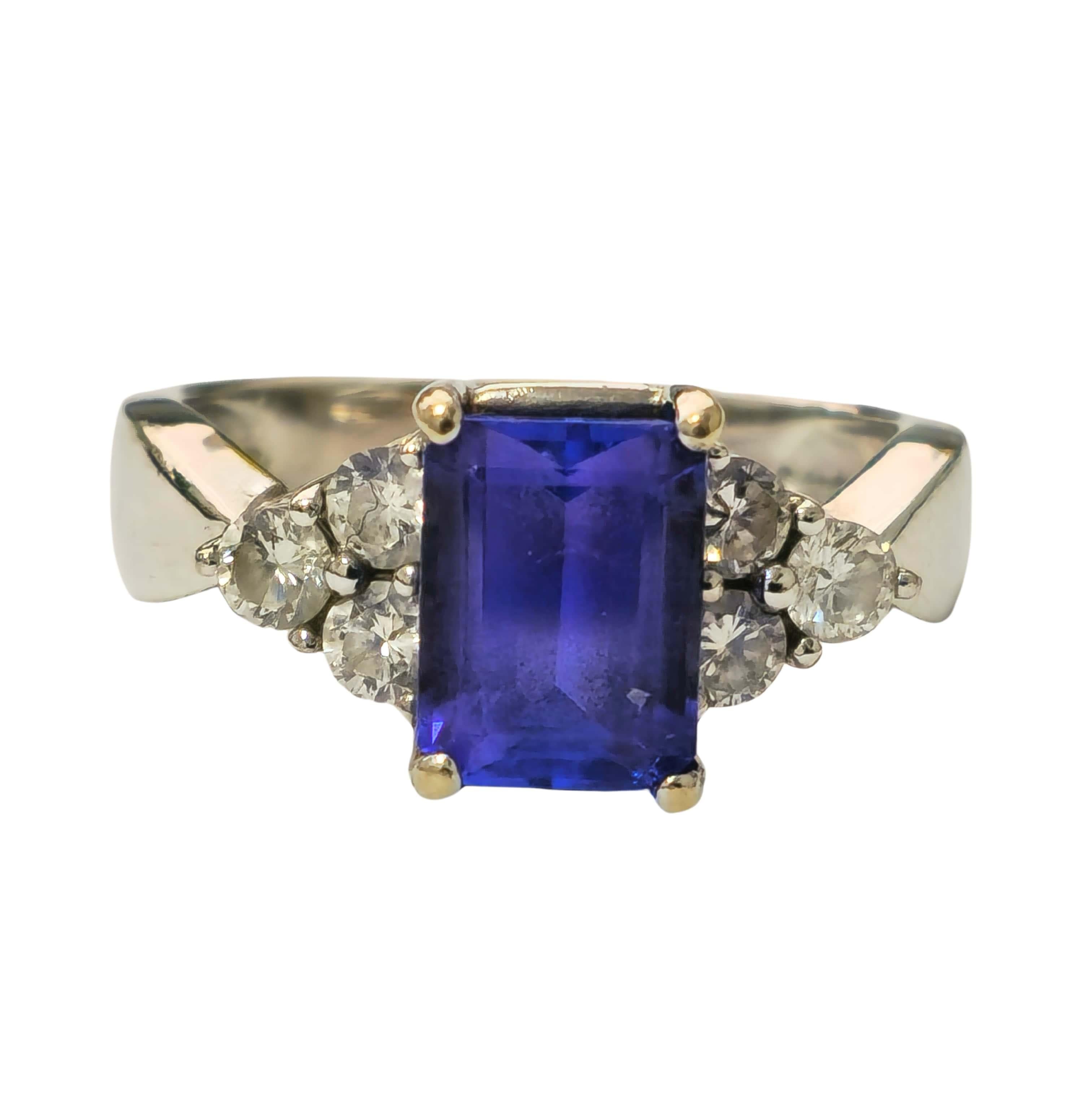 Fashioned from luxurious 14k white gold, this exquisite cocktail ring features a mesmerizing 2.20 carat tanzanite, cut in an elegant emerald shape, sourced directly from the earth's treasures. Accentuating its allure are brilliant diamonds totaling