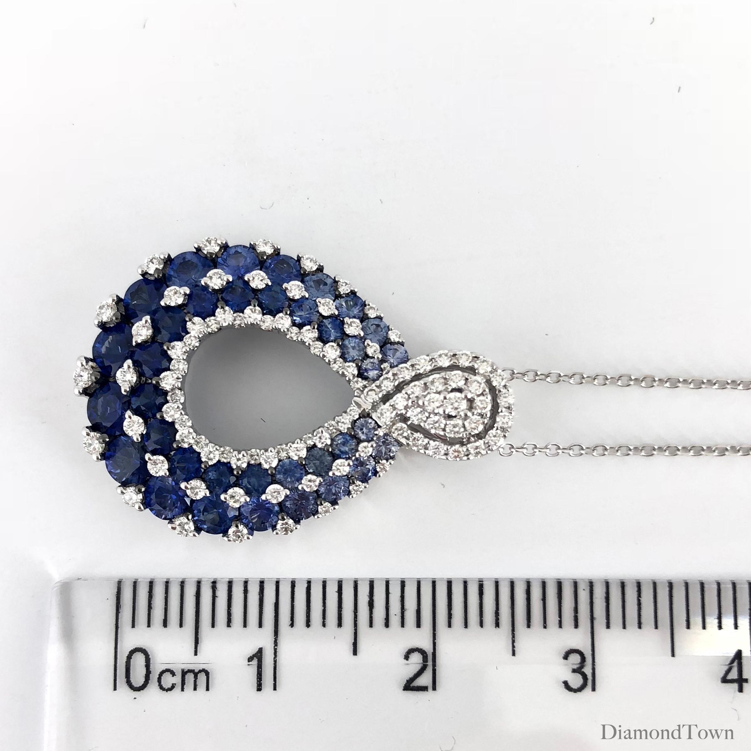 This stunning pendant features 2.20 carats round blue sapphires of graduated size, interlaced with 0.52 carats round natural white diamonds. The overall impression is the grand plumage of a peacock.

Two rows of sapphires total 2.20 carats.
Three