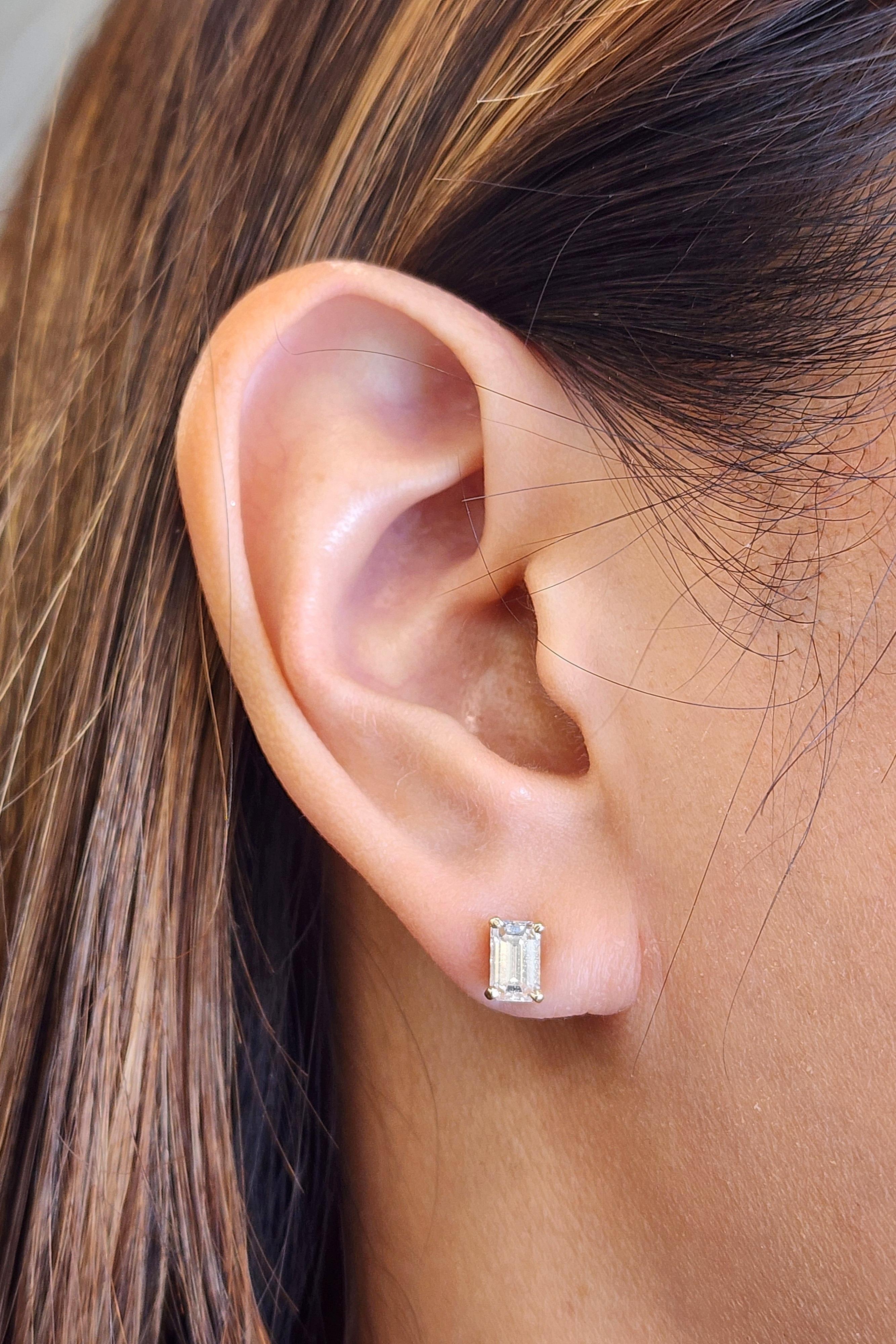 These exquisite earrings features approximately 2.00 ct. mixed-cut white diamonds with a G/H color grade and VS1/VS2 clarity, set in 14k yellow gold. Accentuated by approximately 0.20 ct. baguette-cut blue sapphires, these earrings showcase a