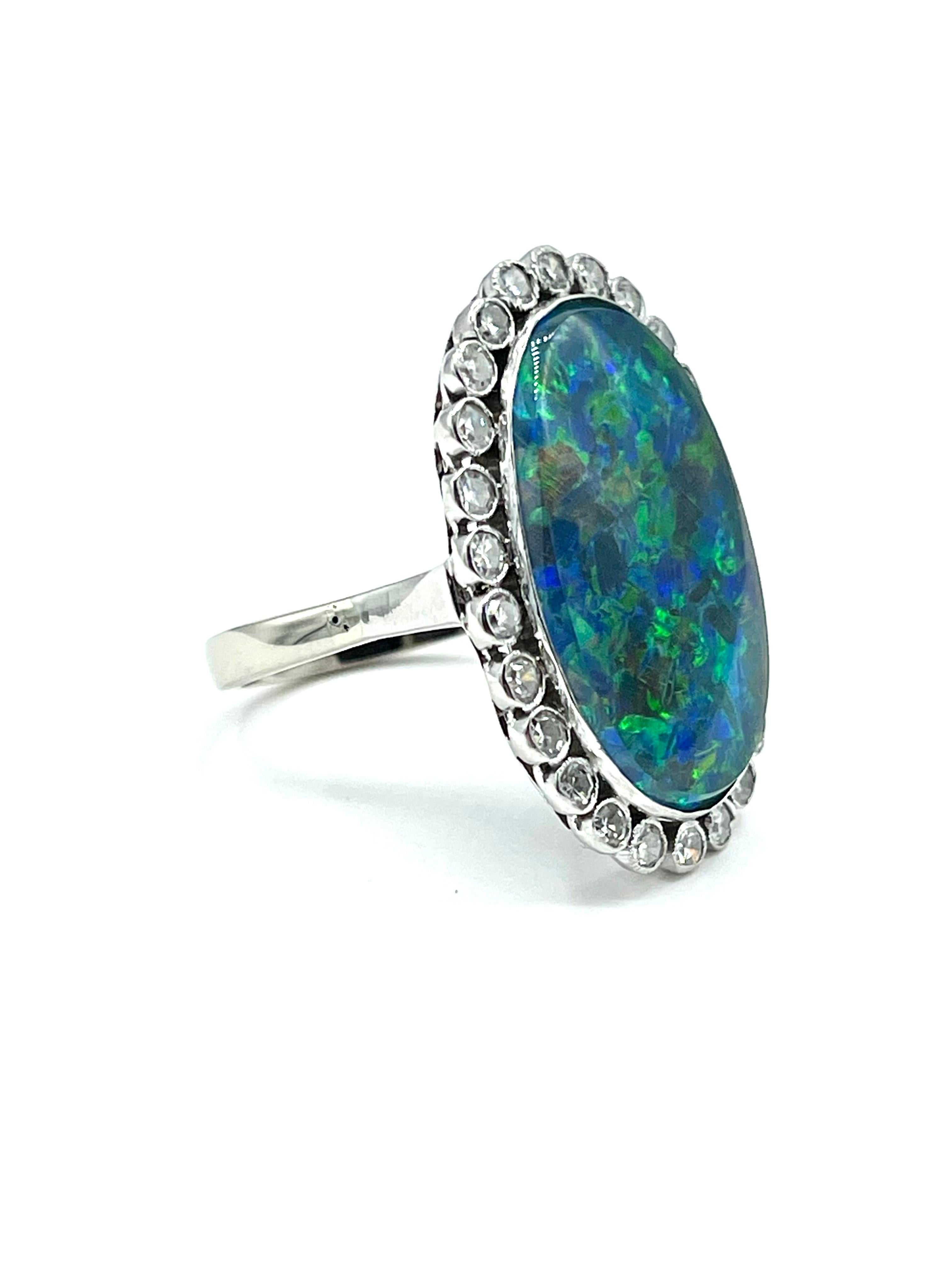 This is a an amazingly colorful cocktail ring!  The 20.00 x 14.00mm Black Opal triplet is bezel set, surrounded by a single row of bezel set single cut Diamonds weighing 0.78 carats total, all in 18K white gold.  The shank of the ring is 2.50mm.  It