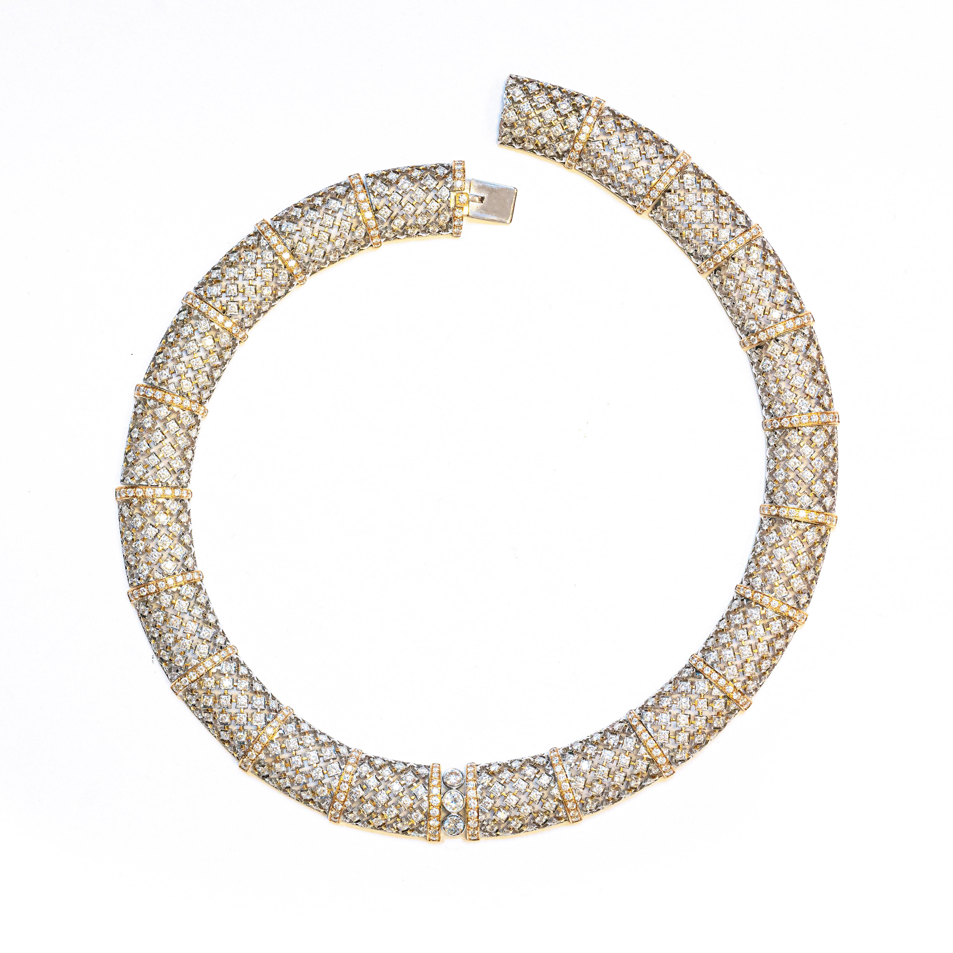 This impressive collar necklace is designed as a seamless series of 21 open work rectangular bombé links, each gracefully grain set with 25 round brilliant cut diamonds, all mounted in 18 carat white gold, open back settings. The open work links are