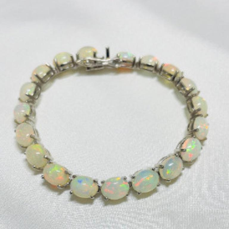 22.04 Carat Genuine Ethiopian Fire Opal Tennis Bracelet in sterling silver showcases endlessly sparkling natural opal, weighing 22.04 carat. It measures 7.25 inches long in length. 
Opal stimulate concentration and reduces stress. 
Designed with