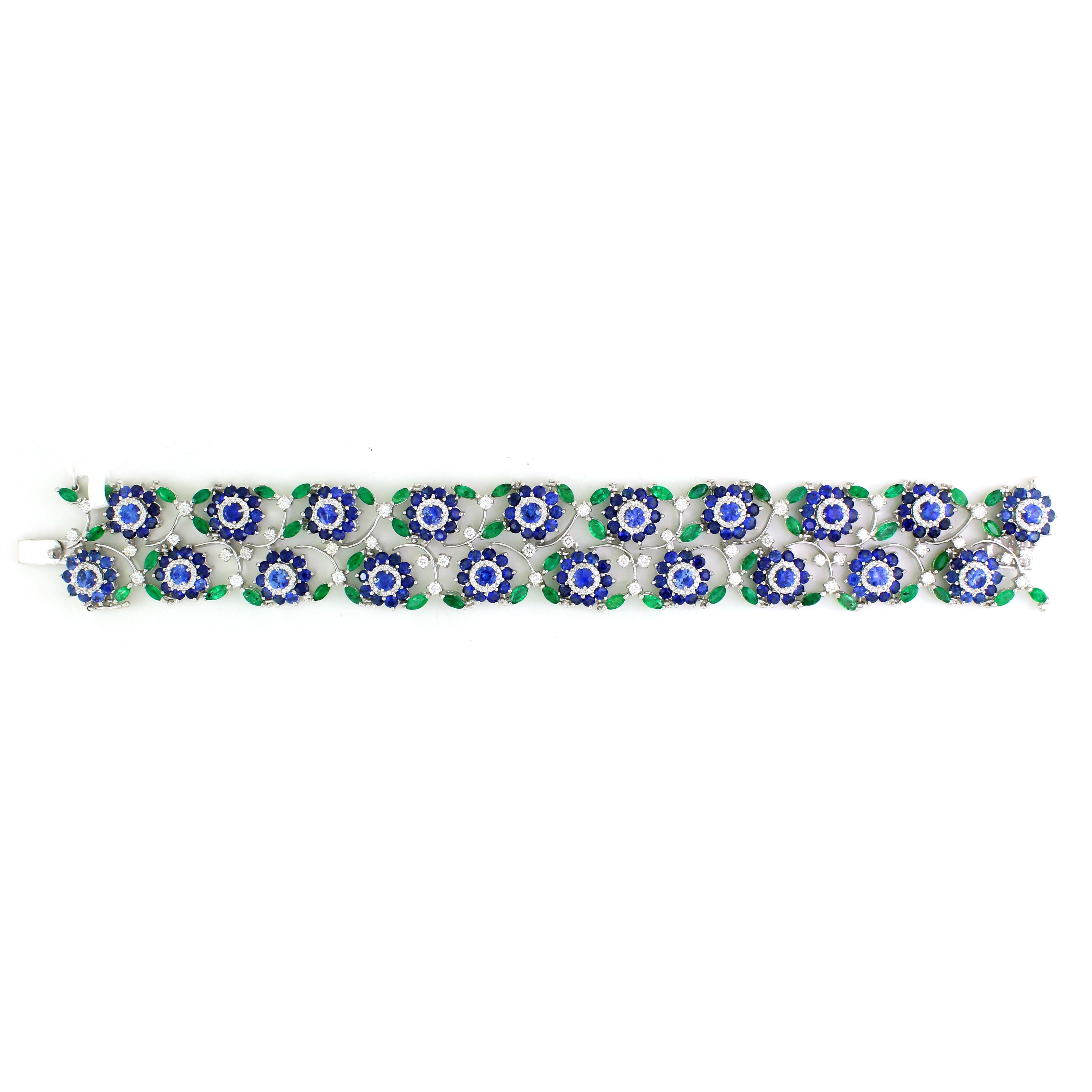 This exquisite link bracelet features a floral-inspired design, masterfully crafted in 14k white gold weighing 46.8 grams. Adorned with 321 white round diamonds totaling 2.76 carats, 55 marquise-cut emeralds amounting to 5.4 carats, and 20 large