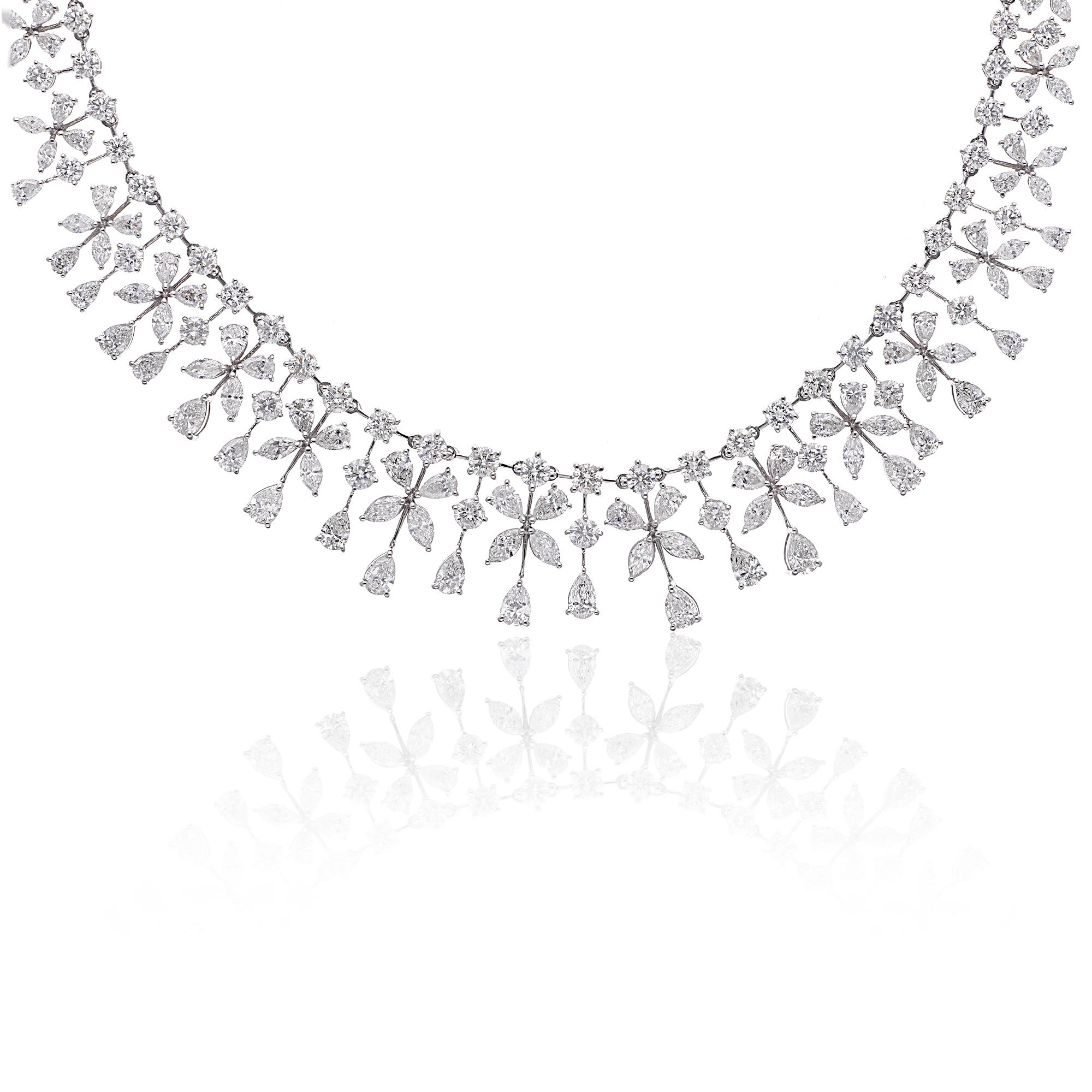 Prepare to be captivated by the mesmerizing beauty of this marquise and pear diamond necklace, boasting an astonishing total carat weight of 22.05 carats. Meticulously handcrafted in 18 karat white gold, this necklace exudes opulence,