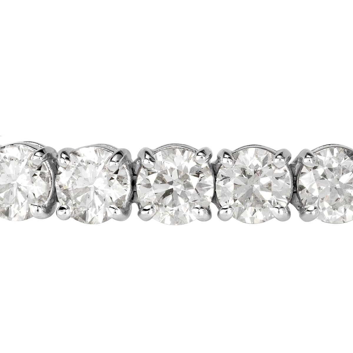 This exceptional diamond tennis bracelet showcases 22.07ct of peerless white round brilliant cut diamonds graded at F-G in color, SI1-SI2 in clarity. They are set in a classic 18k white gold, four-prong setting style. Each of the diamonds average