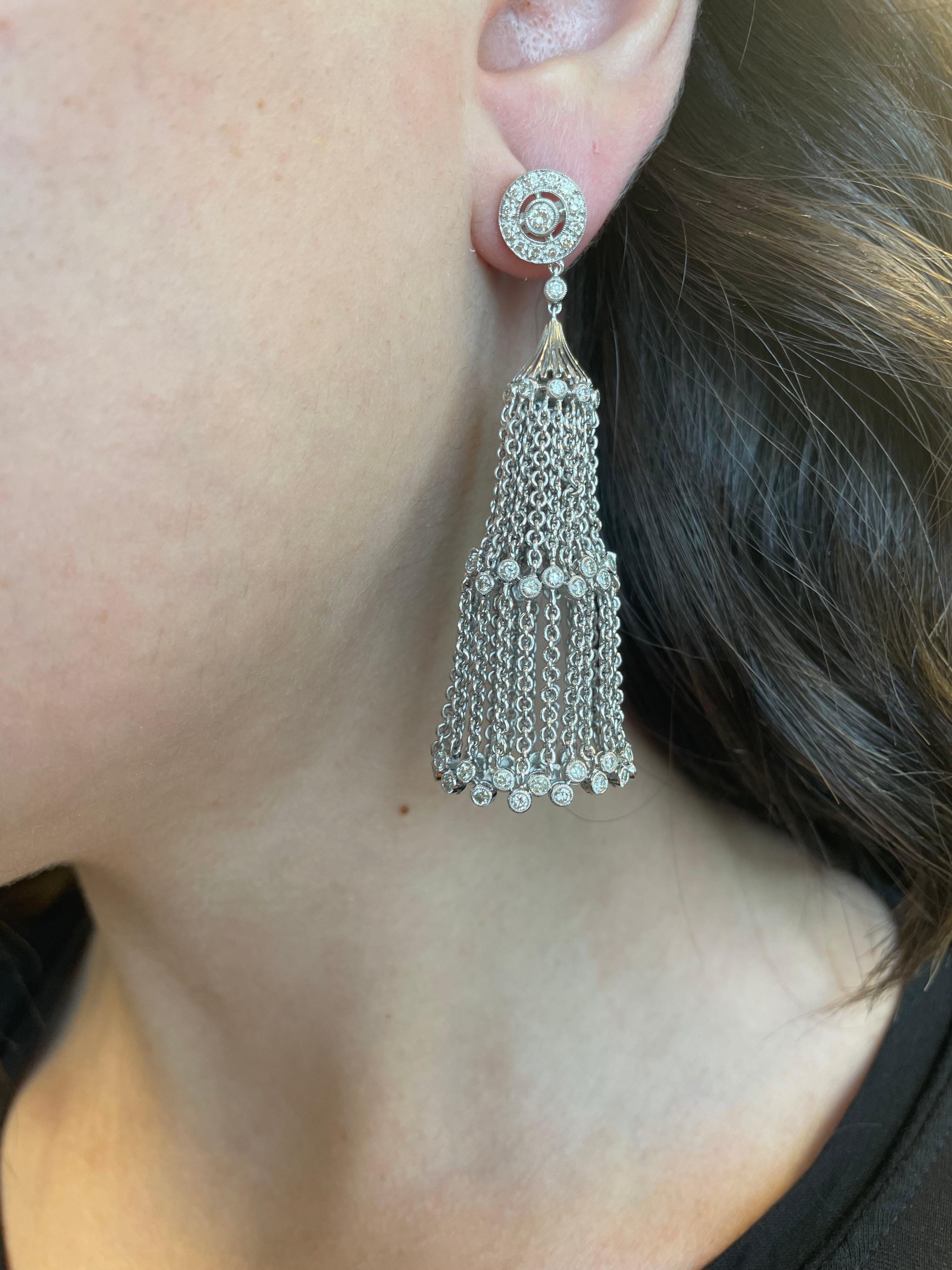 De jolies boucles d'oreilles pendantes en forme de chandelier serties de diamants.
2.20 carats de diamants ronds, de couleur H/I et de pureté SI. Lunette sertie, or blanc 18 carats.
Une évaluation actualisée par un GIA G.G. est fournie sur demande.