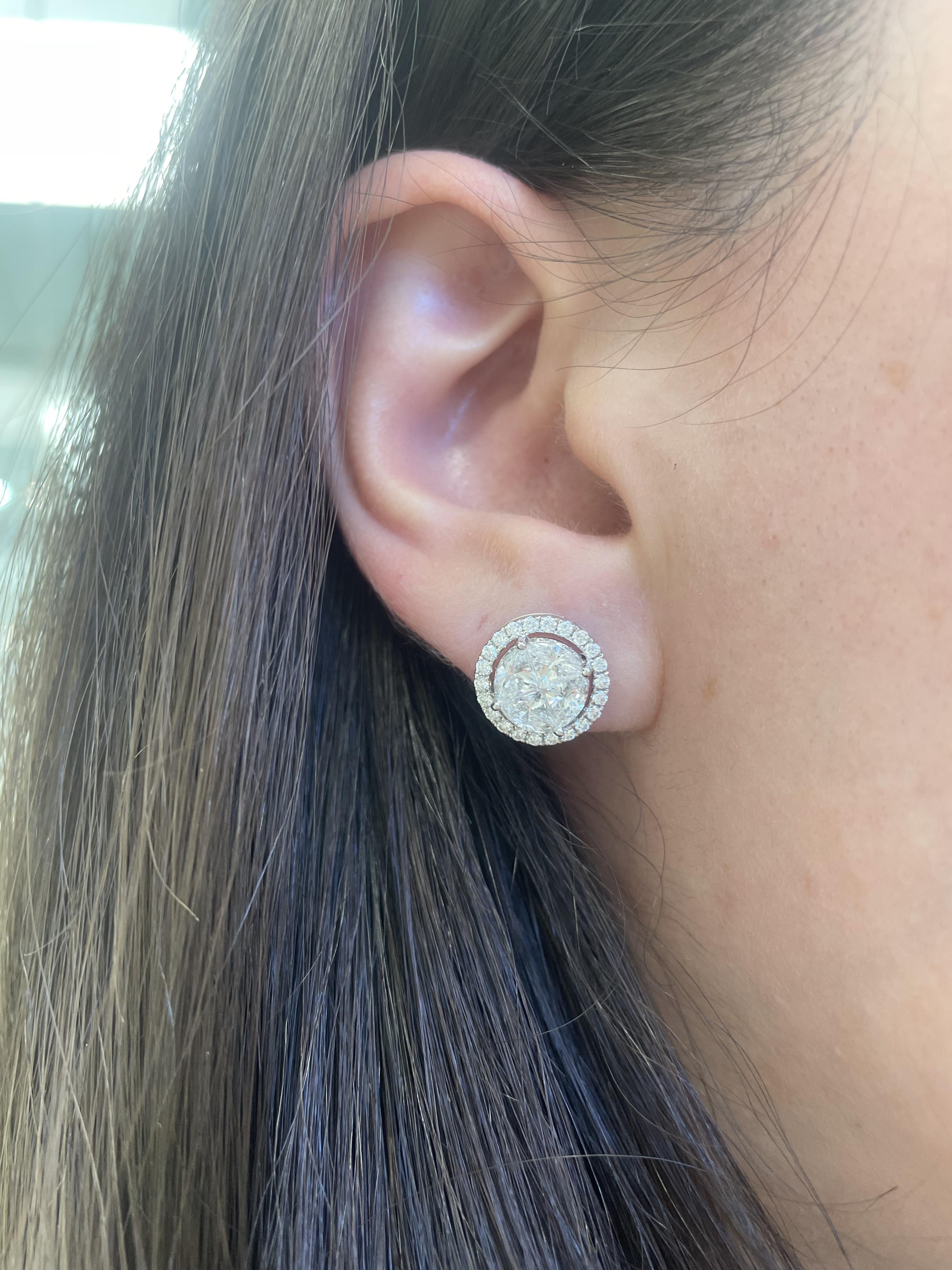 Beautiful illusion set diamond stud earrings with trilliant diamonds.
8 trilliant diamonds, 1.81 carats. Approximately E/F color and VS1 clarity. 44 round diamonds, 0.39 carats. Approximately F color and VS2 clarity. 18k white gold, 4.52