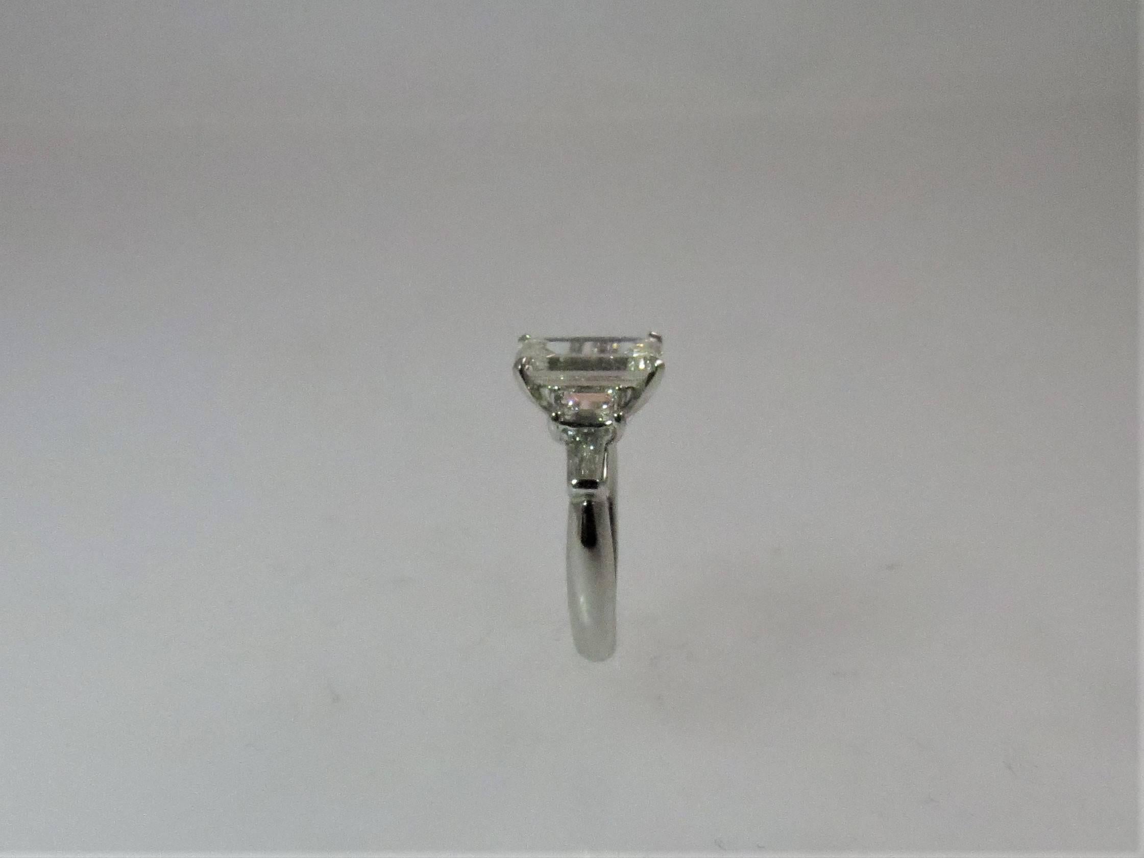 Contemporary 2.20 Carat Emerald Cut Diamond Prong Set in Diamond and Platinum Ring Mounting