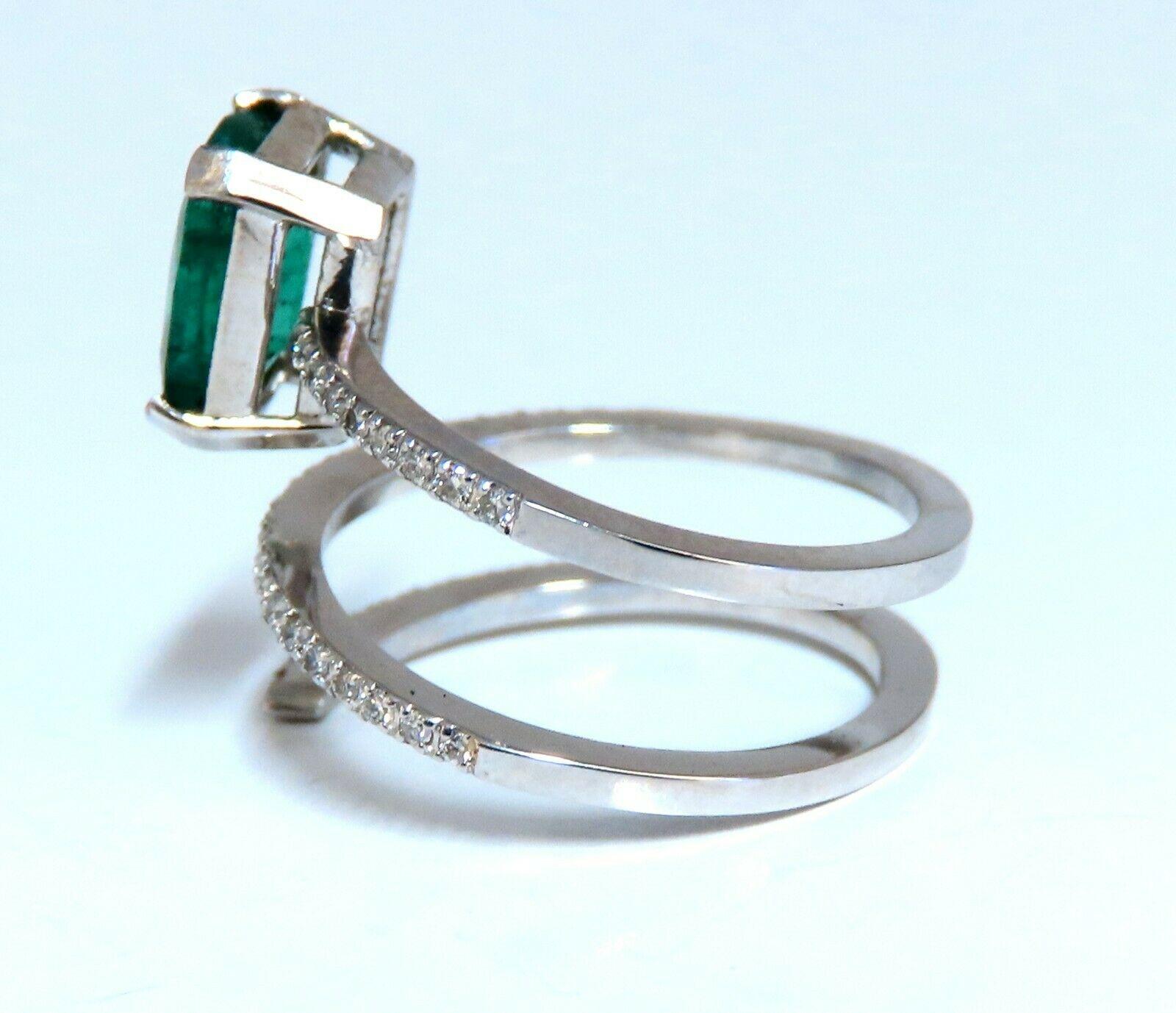 Mod Forest Snake Swirl Green.

1.60ct. Natural Emerald Ring

Emerald, Emerald cut

8.5 x 6.7mm Diameter

Transparent & Vivid Green 

.60ct. Diamonds.

Round & full cuts 

G-color Vs-2 clarity.  

14kt. white gold

4.1 grams

Ring Current size: 6-7
