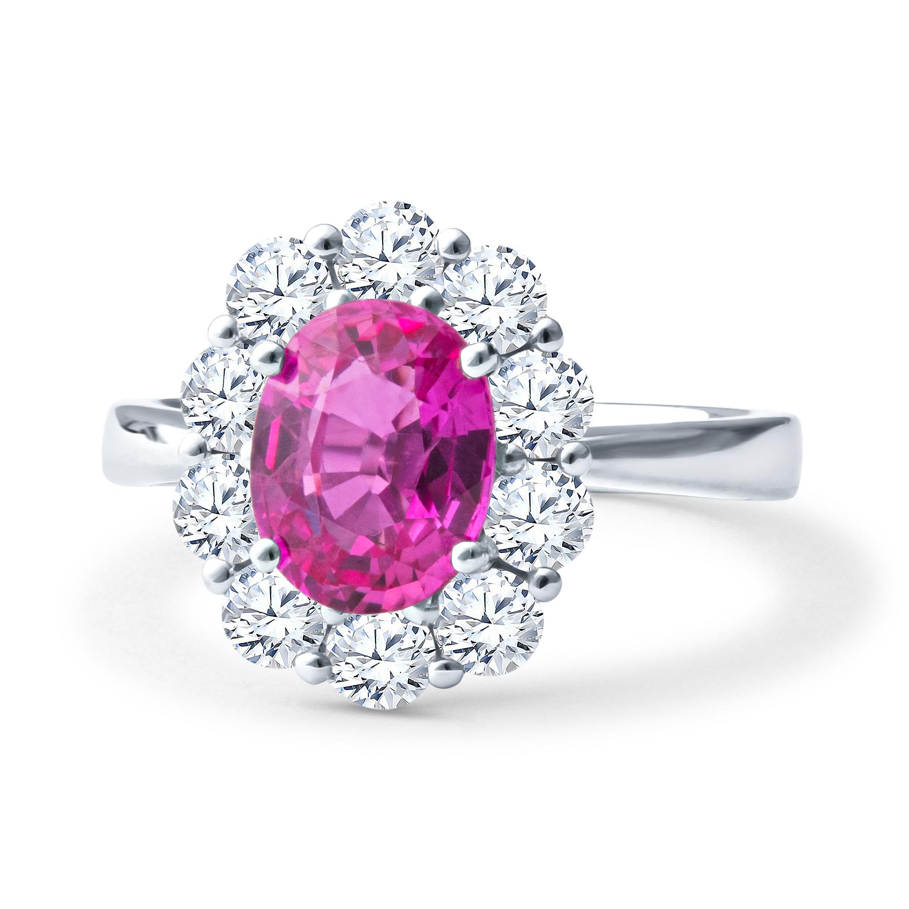 This gorgeous ring features a 2.20ct pink sapphire centerstone in an oval shape, with an intense saturation and an electric pink hue, surrounded by a 1.17ct total weight in round diamonds making a halo around the sapphire and forming a floral shape.