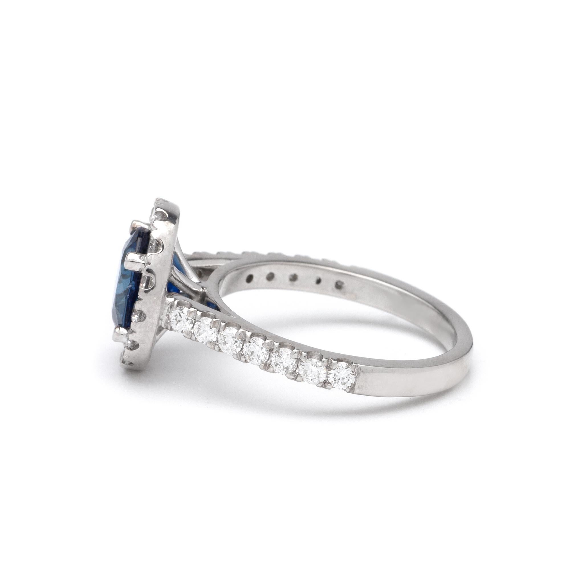 This ring features a halo design of G color, SI1 clarity, and 1.11ct Round side diamonds set in 14K white gold. The center gemstone is a 2.20ct Oval blue sapphire measuring 8.17 x 7.00mm. Finger size 6 1/2 with free resizing.