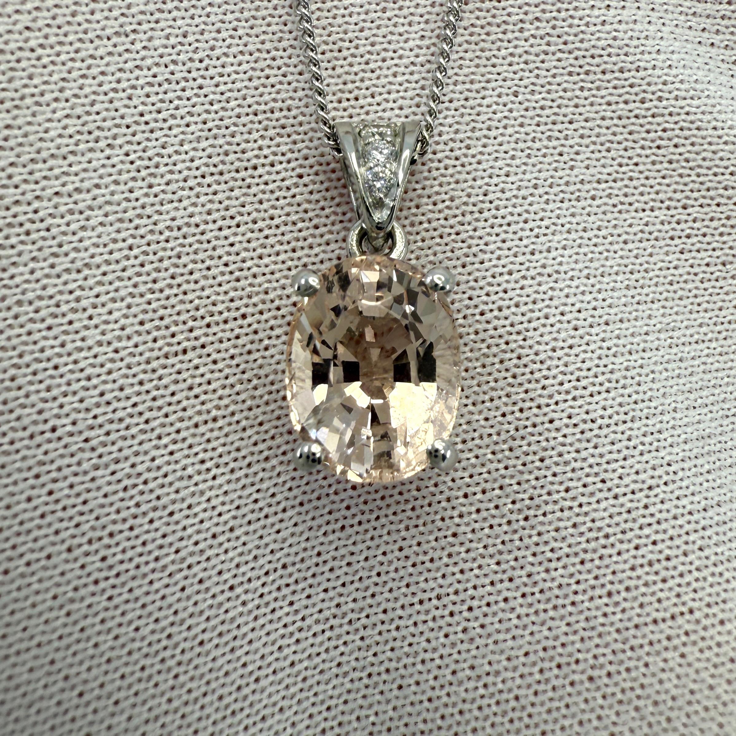 Natural Peach Pink Orange Morganite & Diamond Platinum Pendant Necklace.

2.20 Carat Morganite with a beautiful peach pinkish orange colour and very good clarity. A clean stone with only some small natural inclusions visible when looking closely.