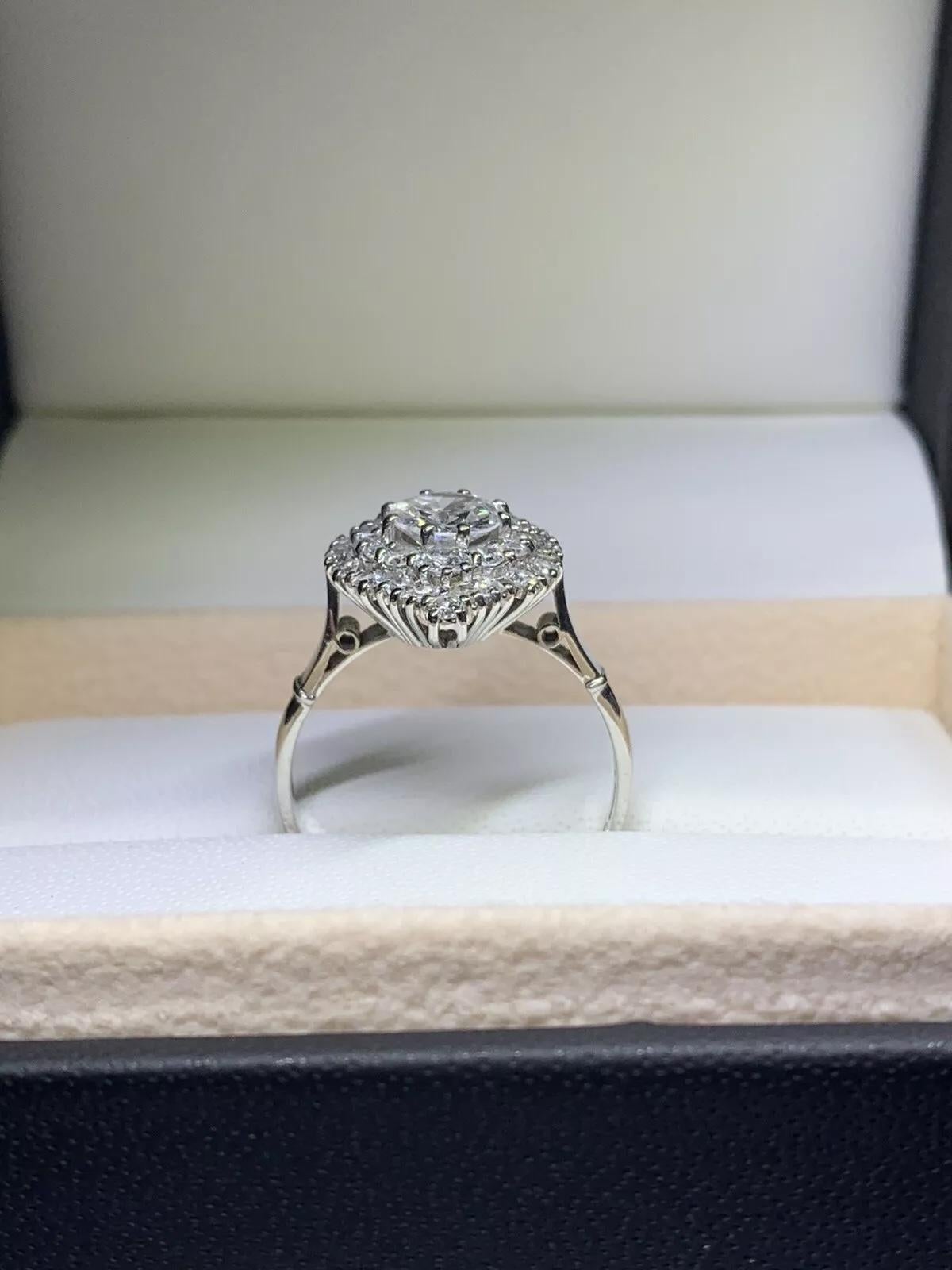 2.20ct round diamond antique engagement ring in platinum.

Large round diamond shaped with additional cluster diamond setting around marquise diamond illusion set engagement ring in platinum.

Centre diamond weight 1.10ct H colour VS1