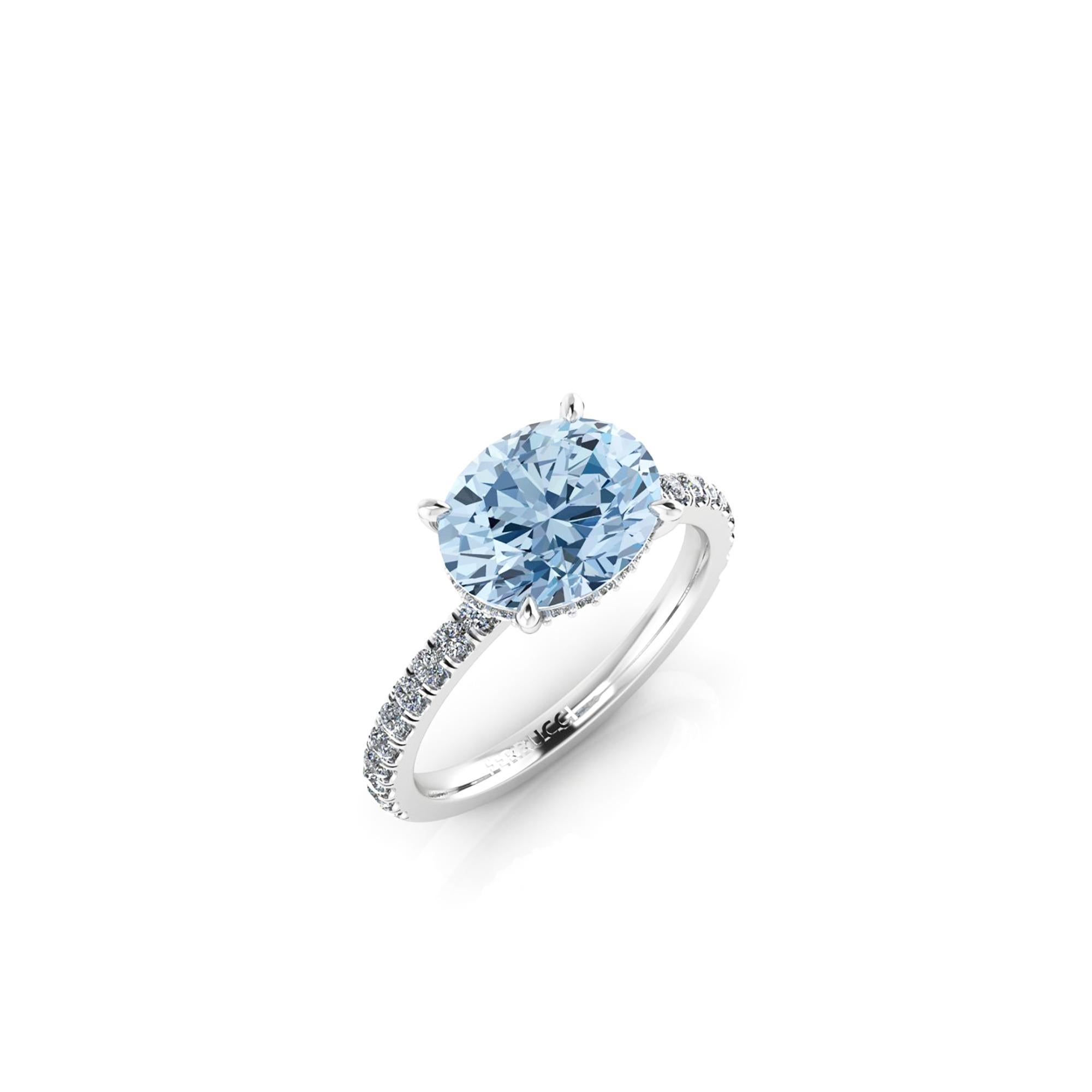 A  2.21 carat horizontal, set east to west Oval blue Aquamarine, set on a Platinum 950 ring, designed and hand made in New York 
adorned by white round diamonds, hand set, for an approximate 0.60 carats, for a maximum shine and sparkle.

This ring's